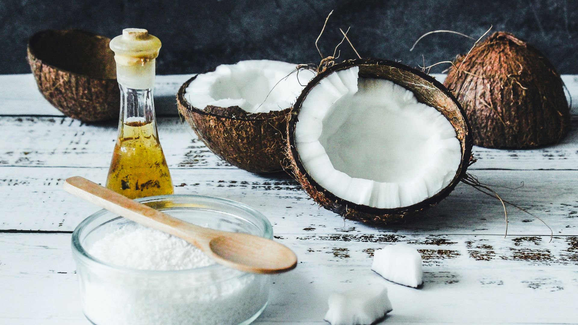 white powder in clear glass jar beside brown wooden spoon