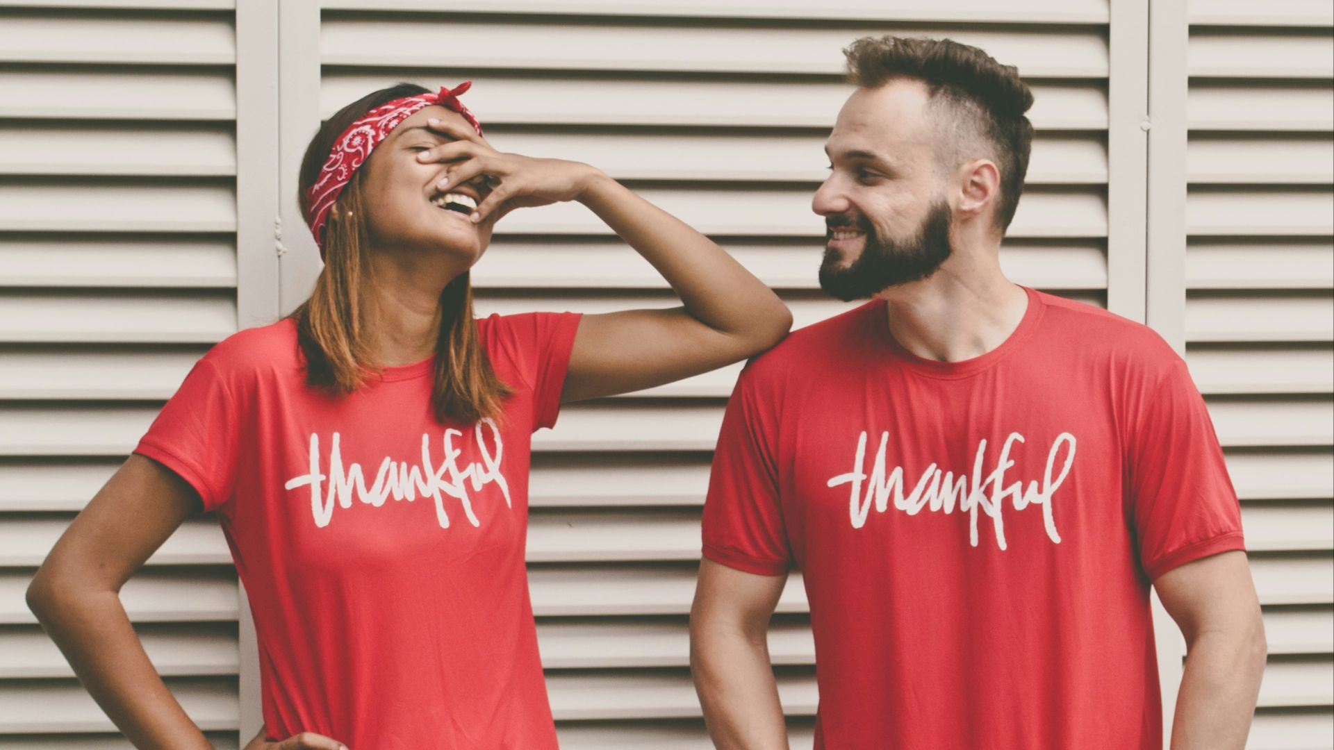 man and woman standing in front of louver door