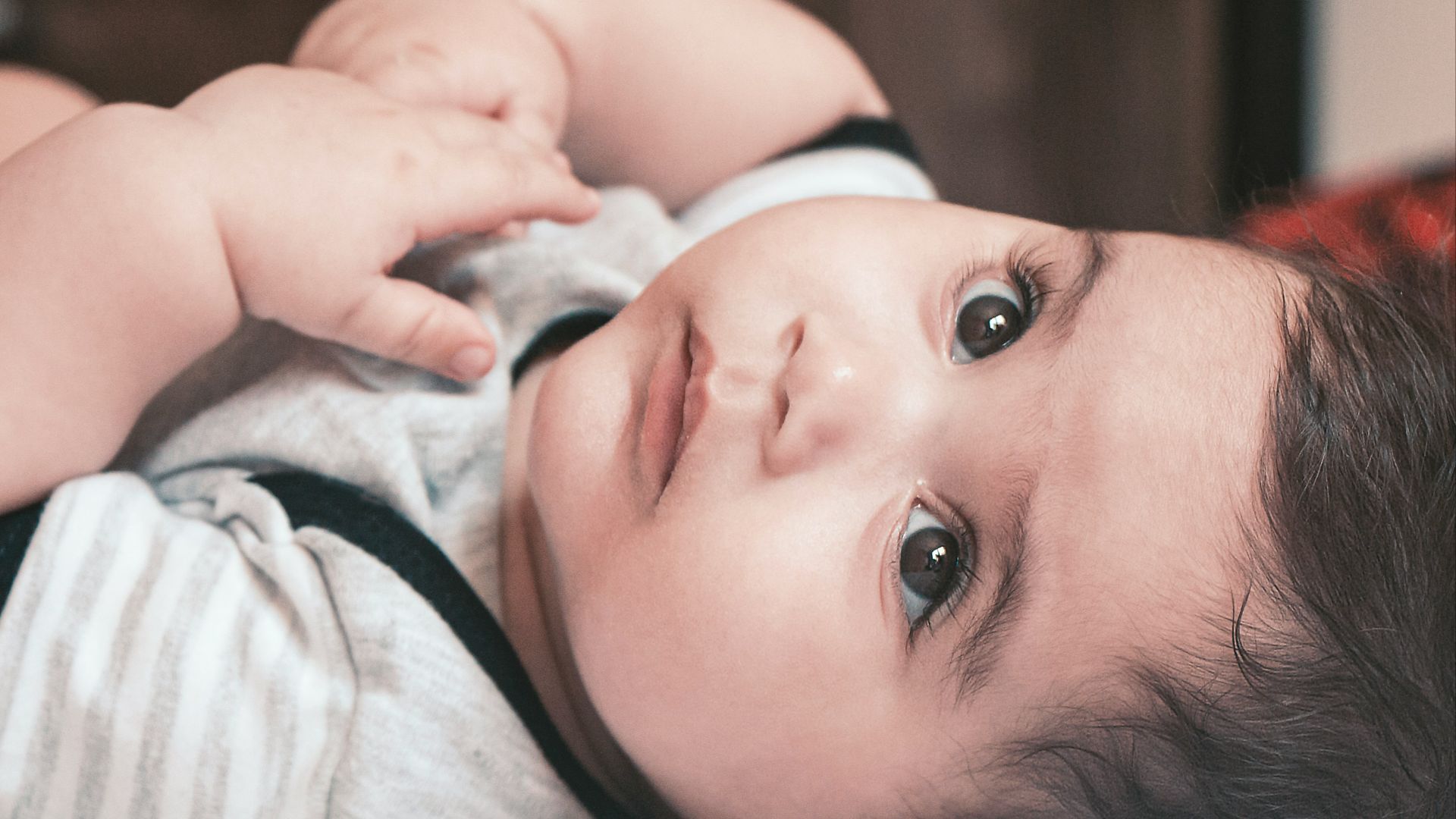 baby in white and pink shirt