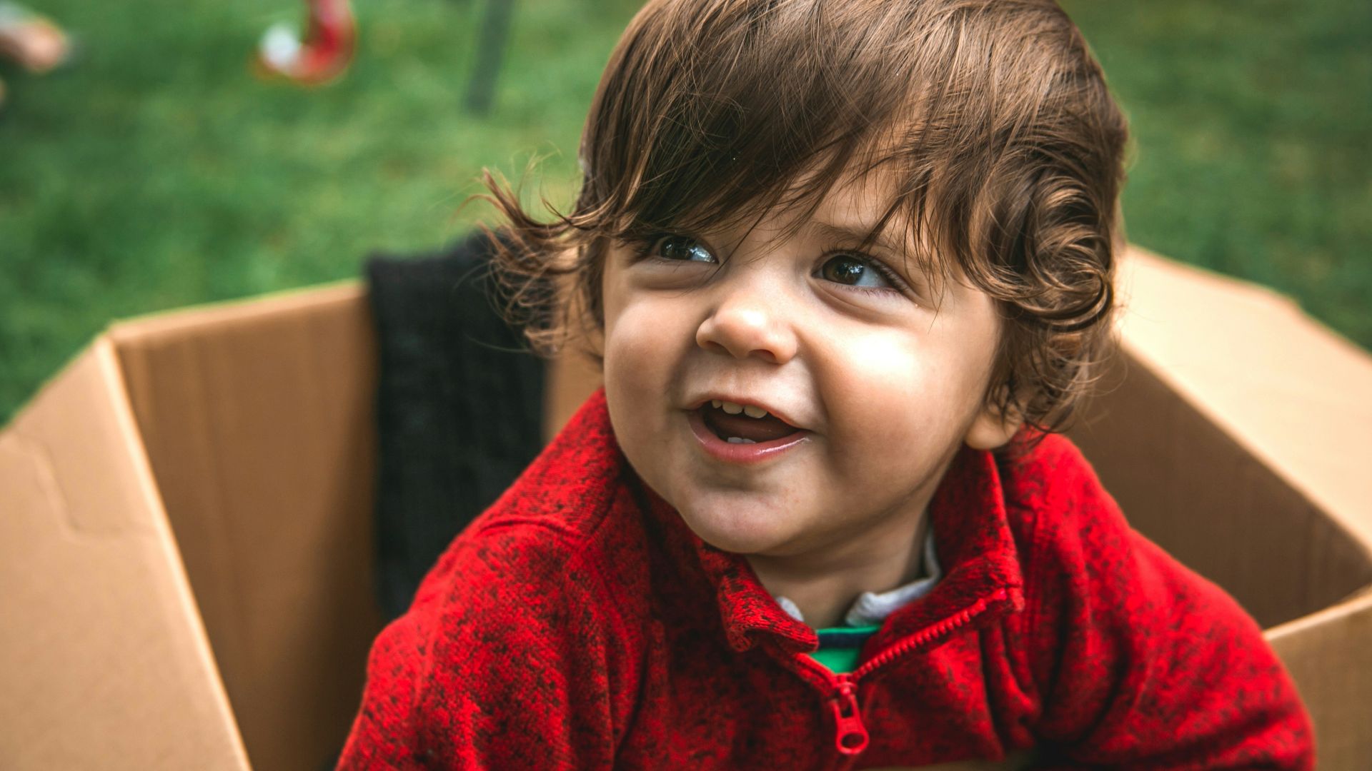 girl in red zip up hoodie smiling