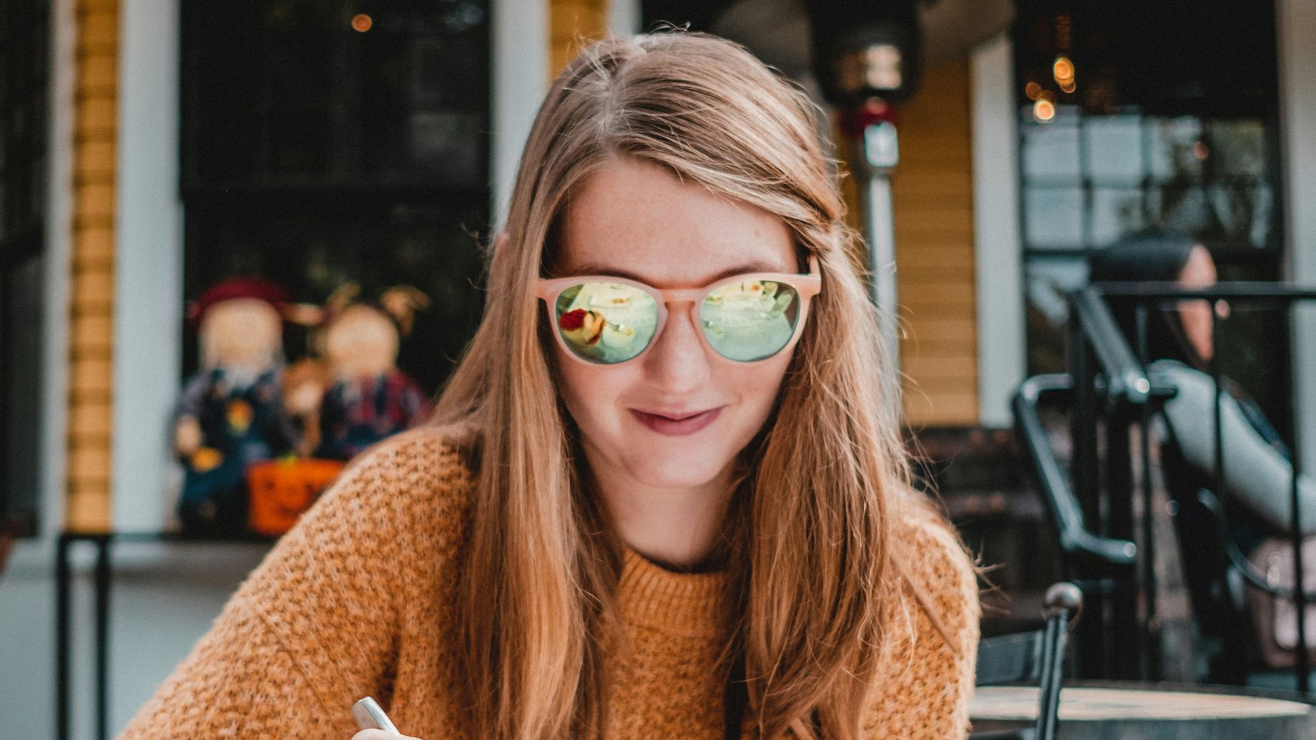 a woman sitting at a table with a plate of food