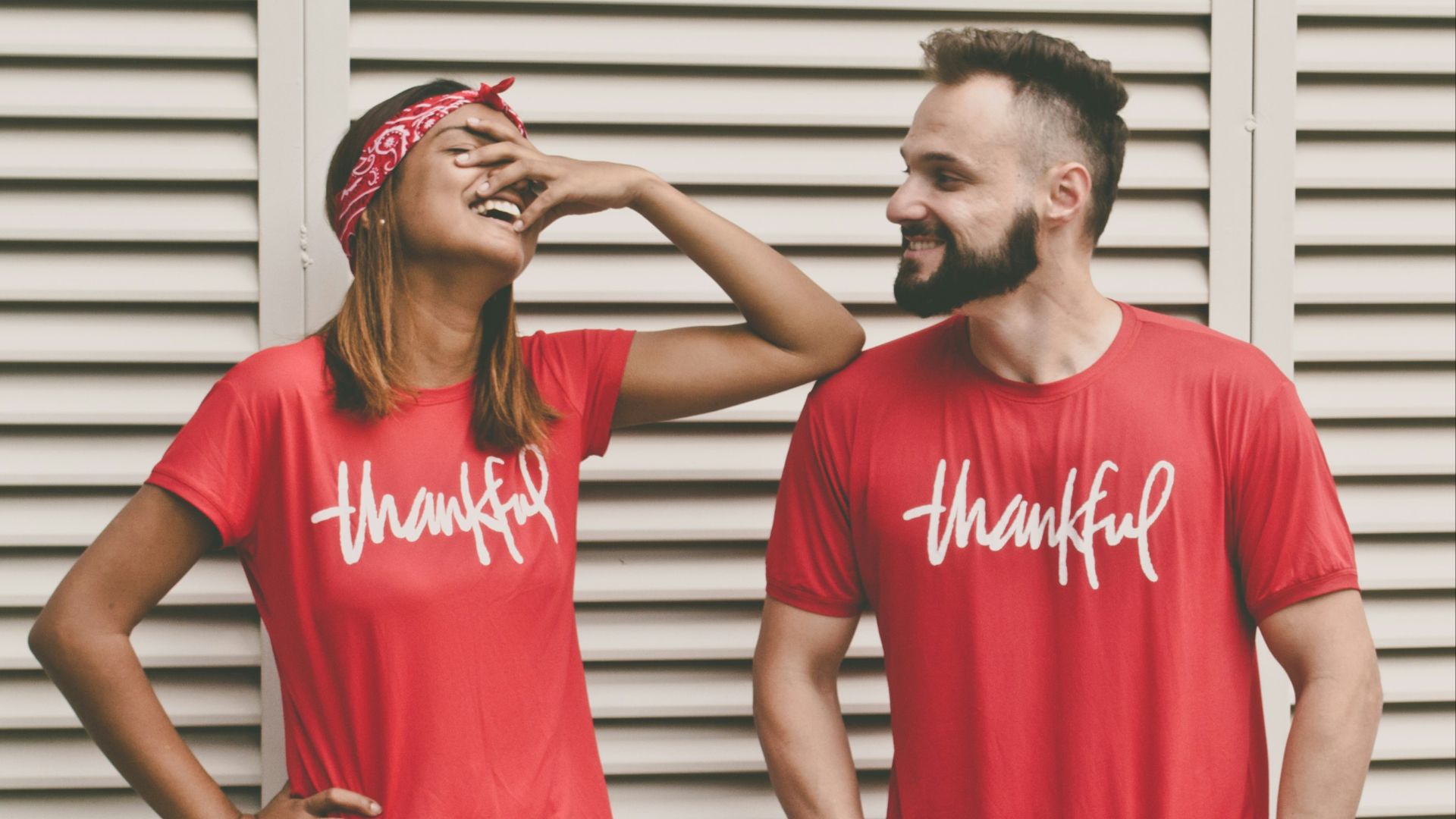 man and woman standing in front of louver door