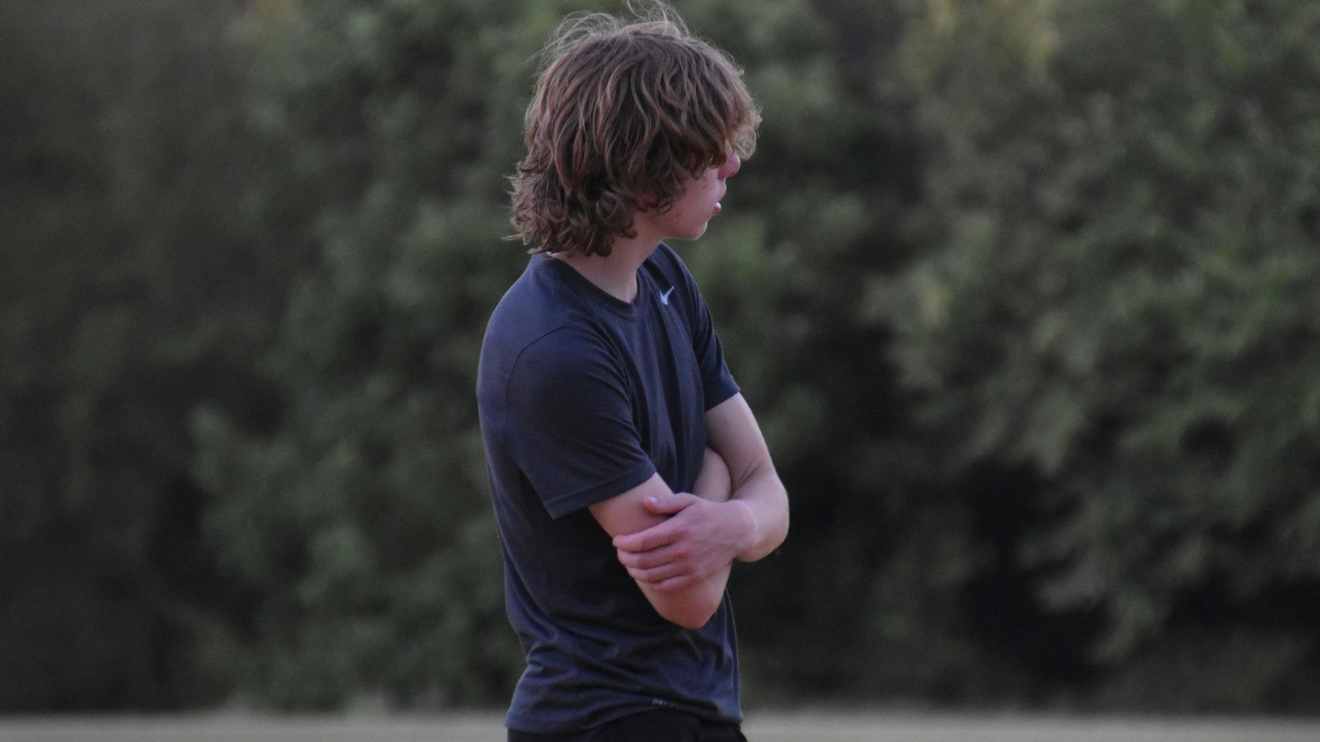 a man standing in a field holding a frisbee
