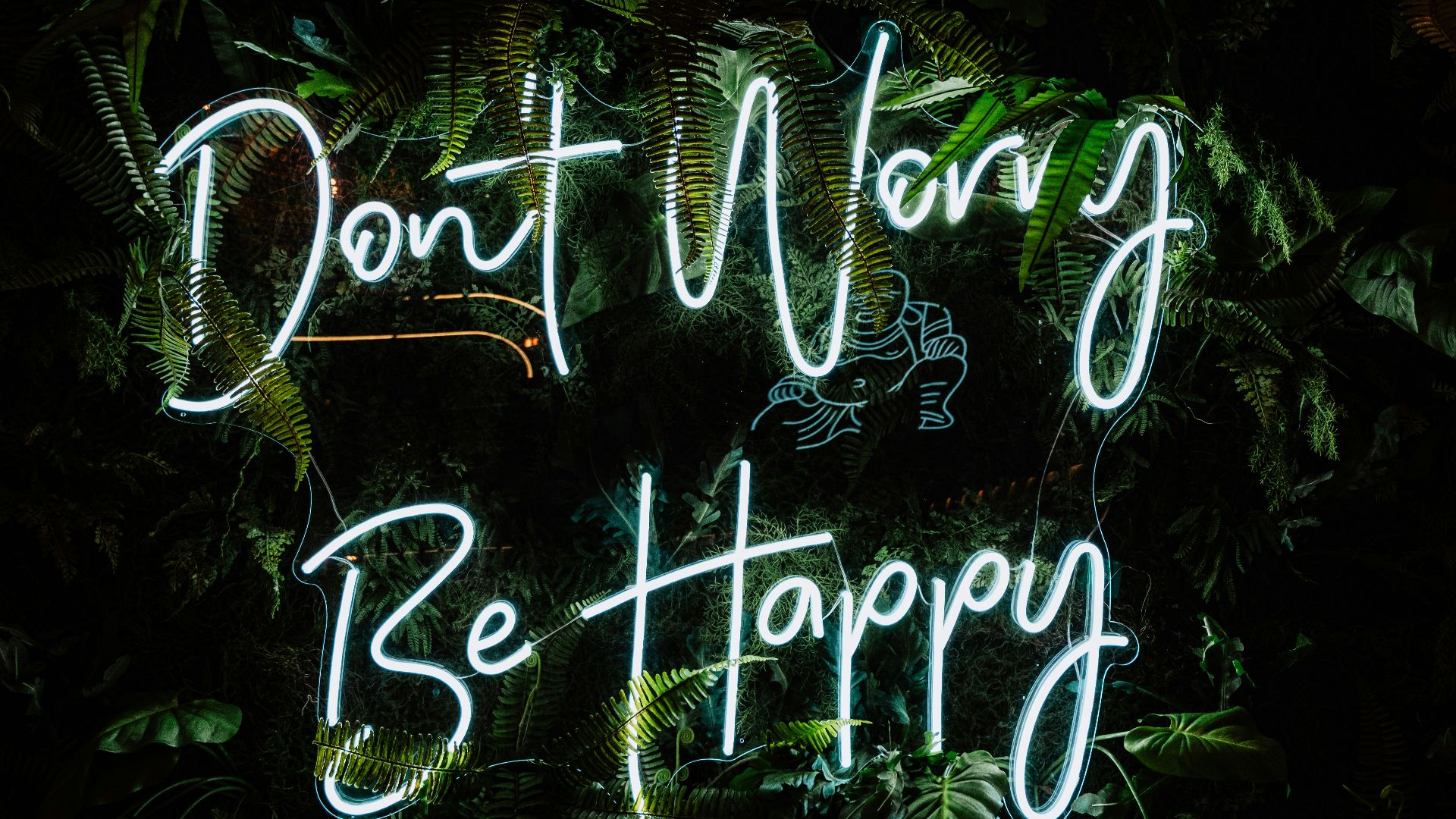 a neon sign that says don't worry be happy