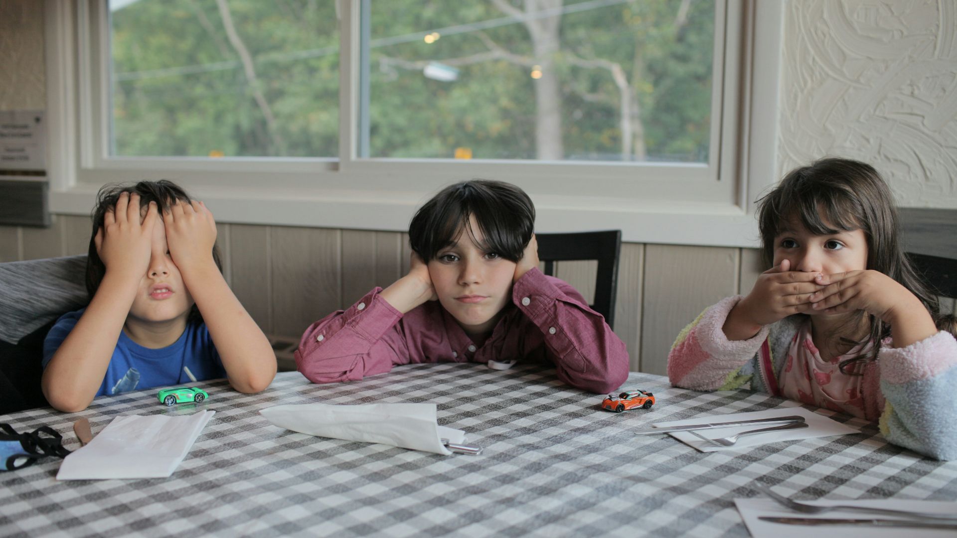 2 women sitting on chair in front of table