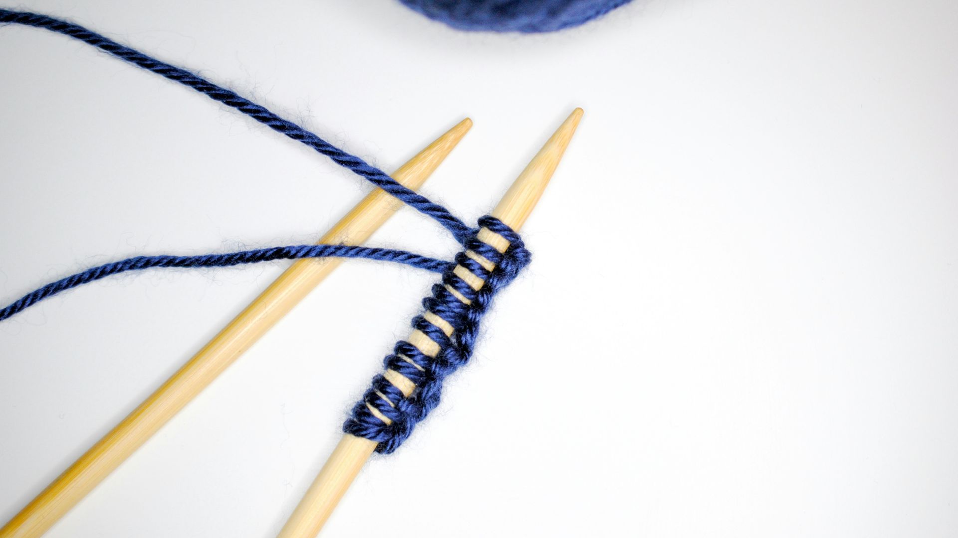 white and gray yarn on white background