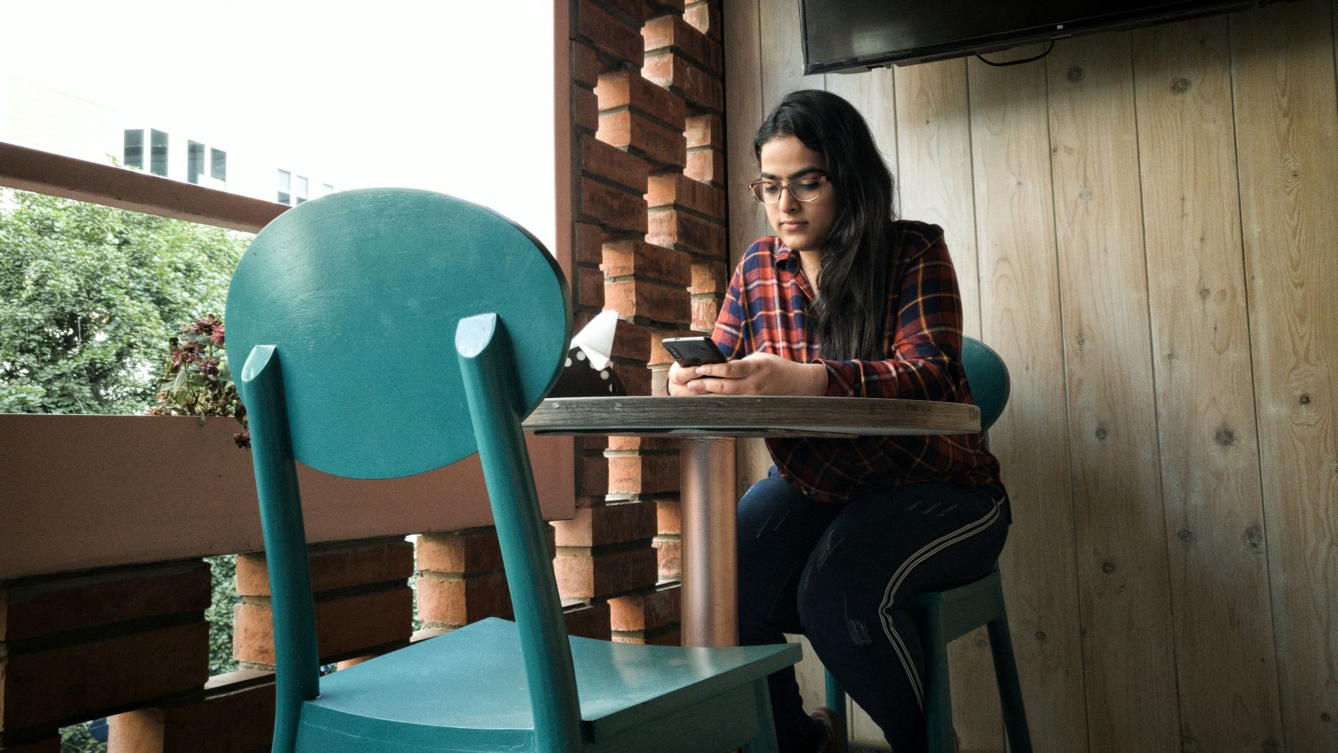 woman leaning on pedestal table