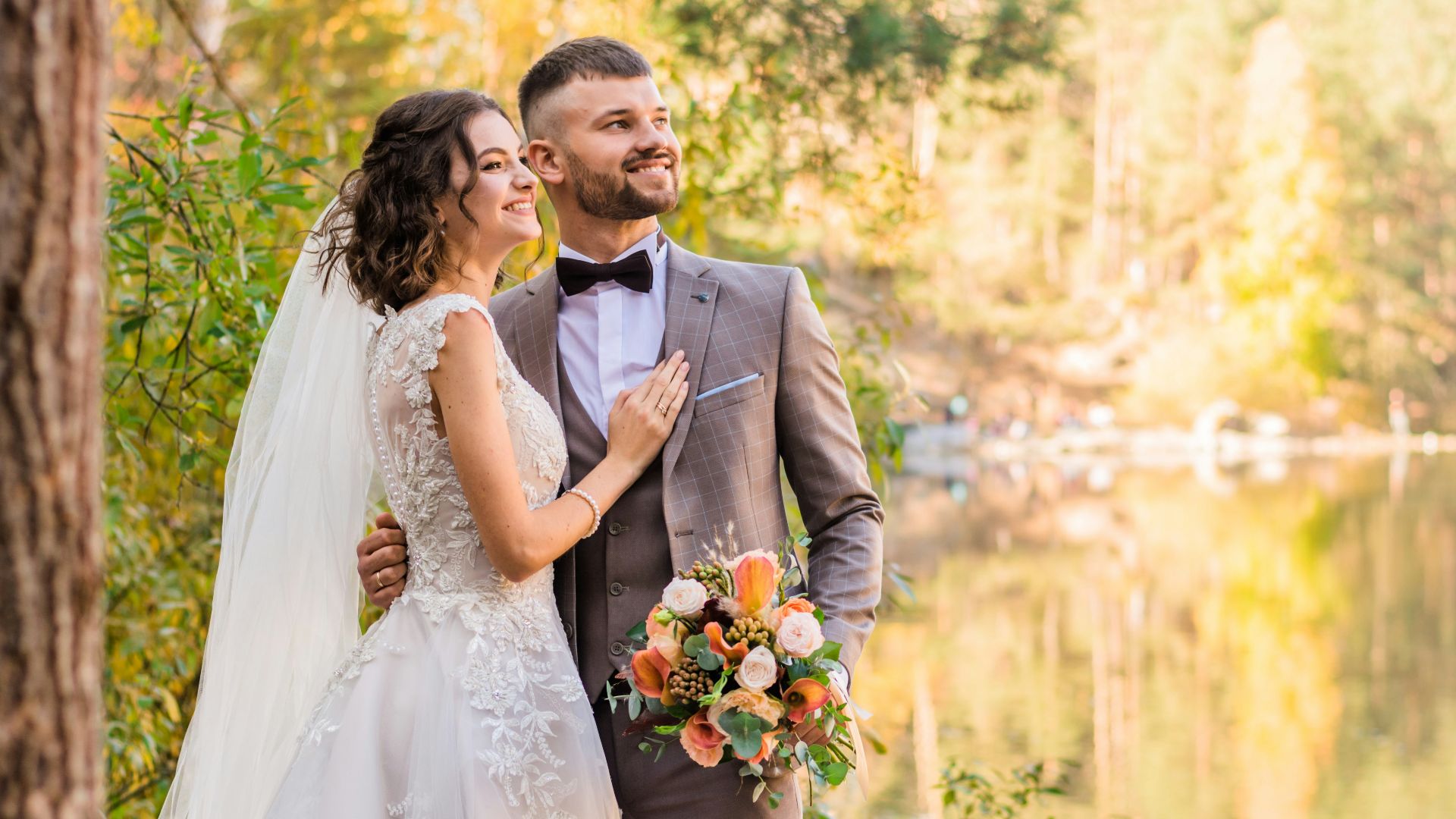 man in gray suit and woman in white wedding dress