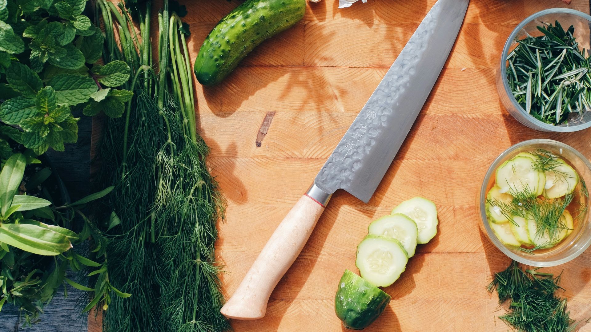 sliced cucumber and green vegetable on brown wooden chopping board