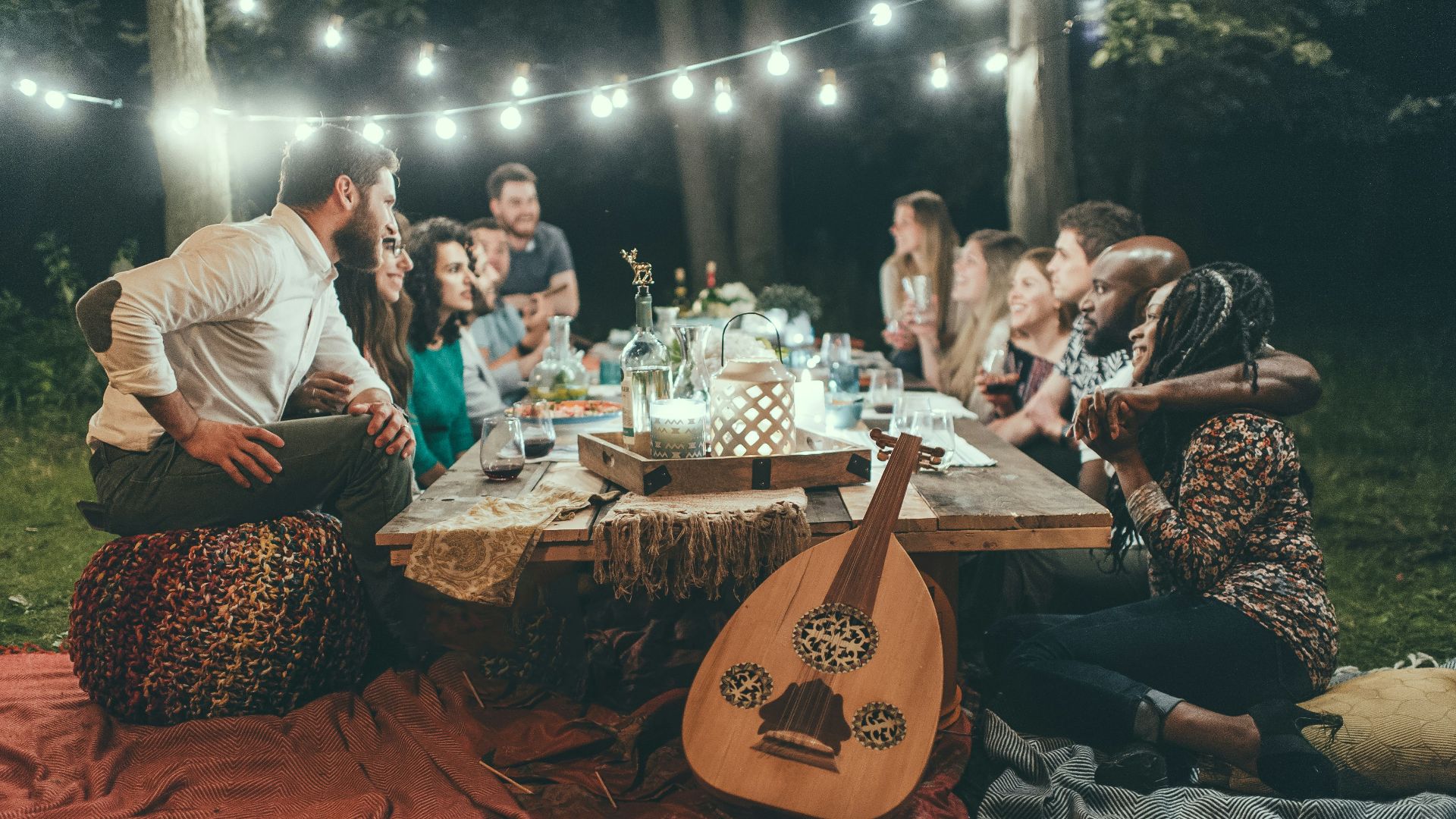 people sitting on chair in front of table with candles and candles