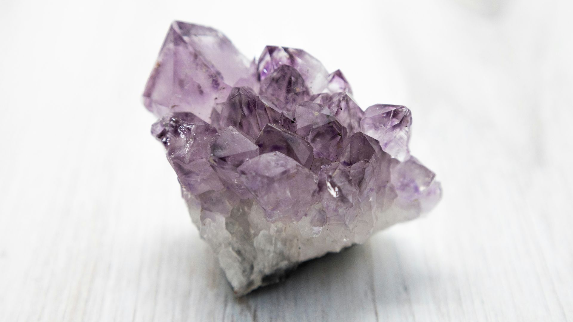 purple crystal on white table