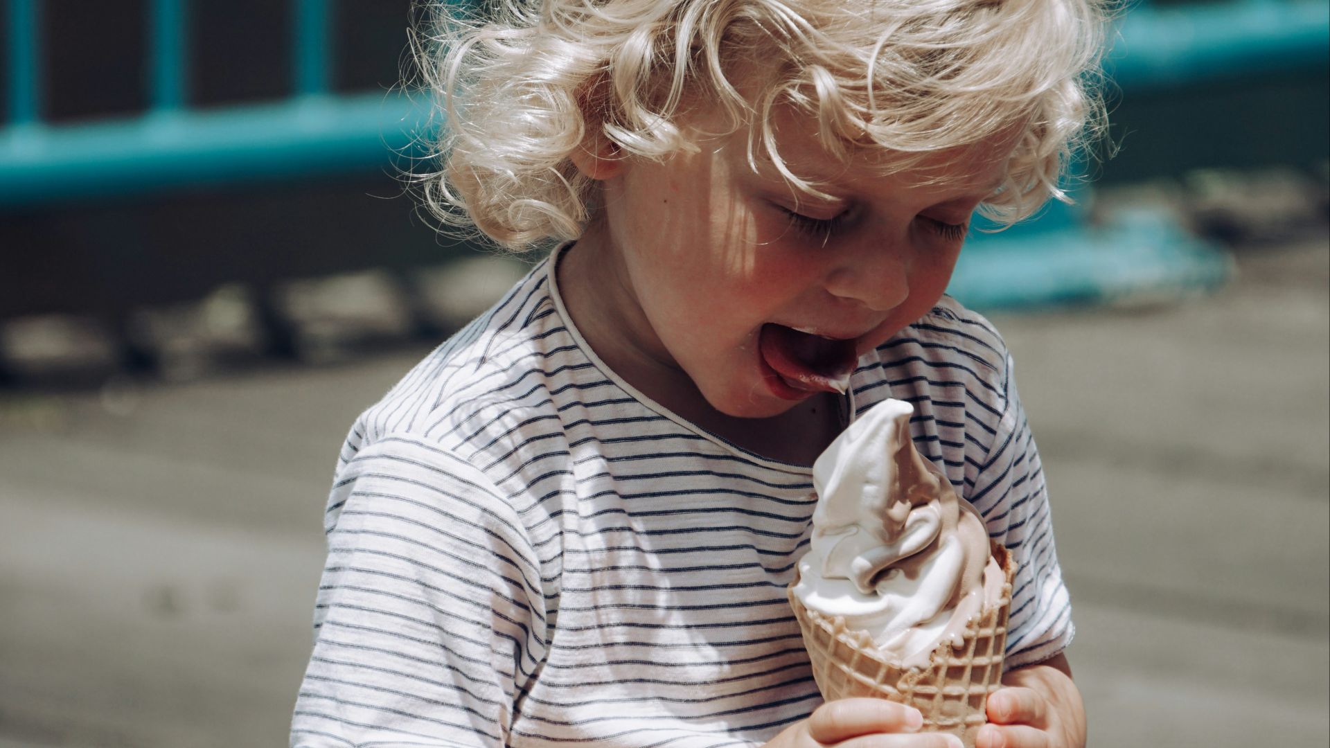 a child holding an ice cream cone