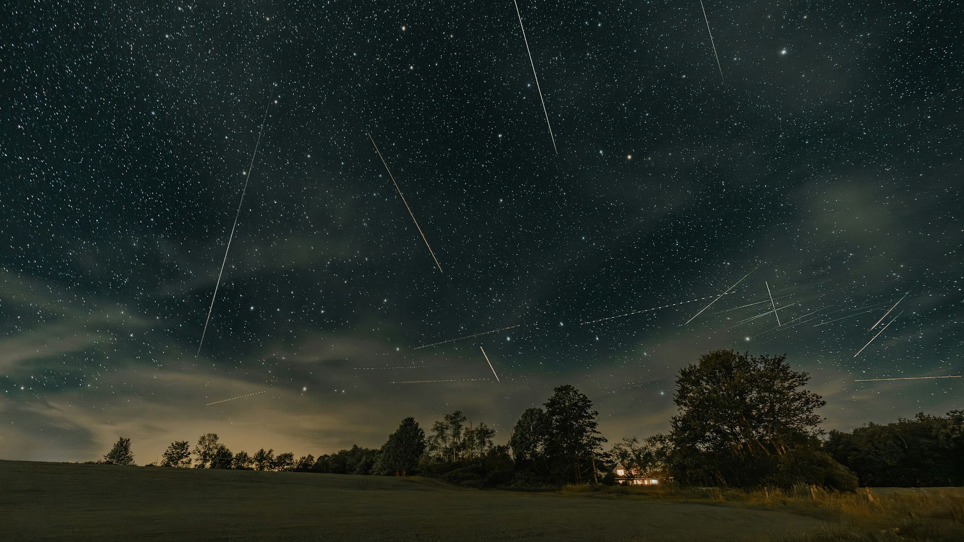 a night sky filled with stars and shooting stars