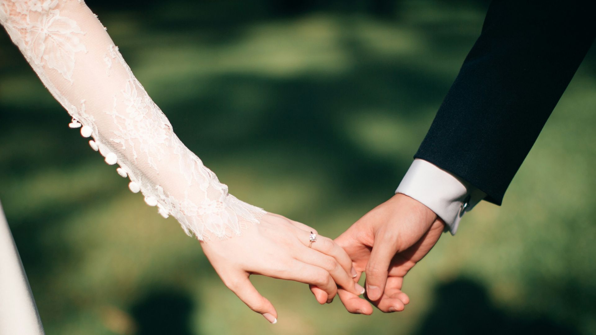 man and woman holding hands focus photo