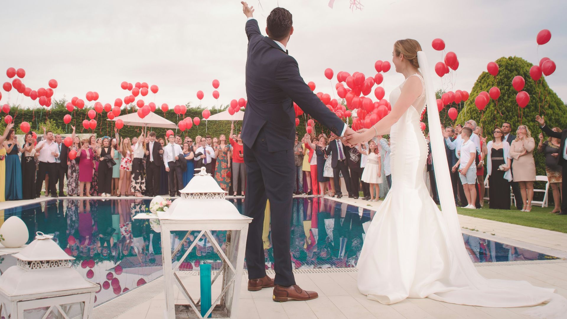 photo of a man and woman newly wedding holding a balloons