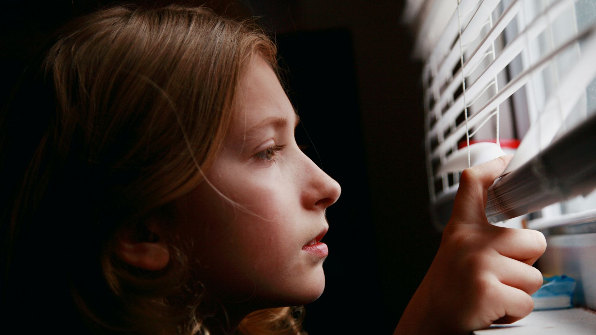 girl in blue shirt holding smartphone