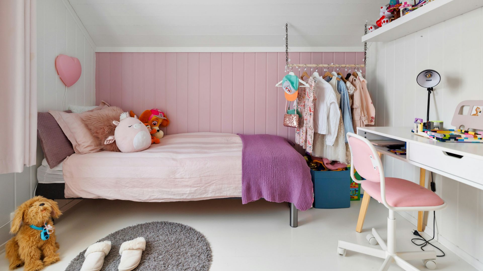 A child's bedroom with a bed, desk, and chair