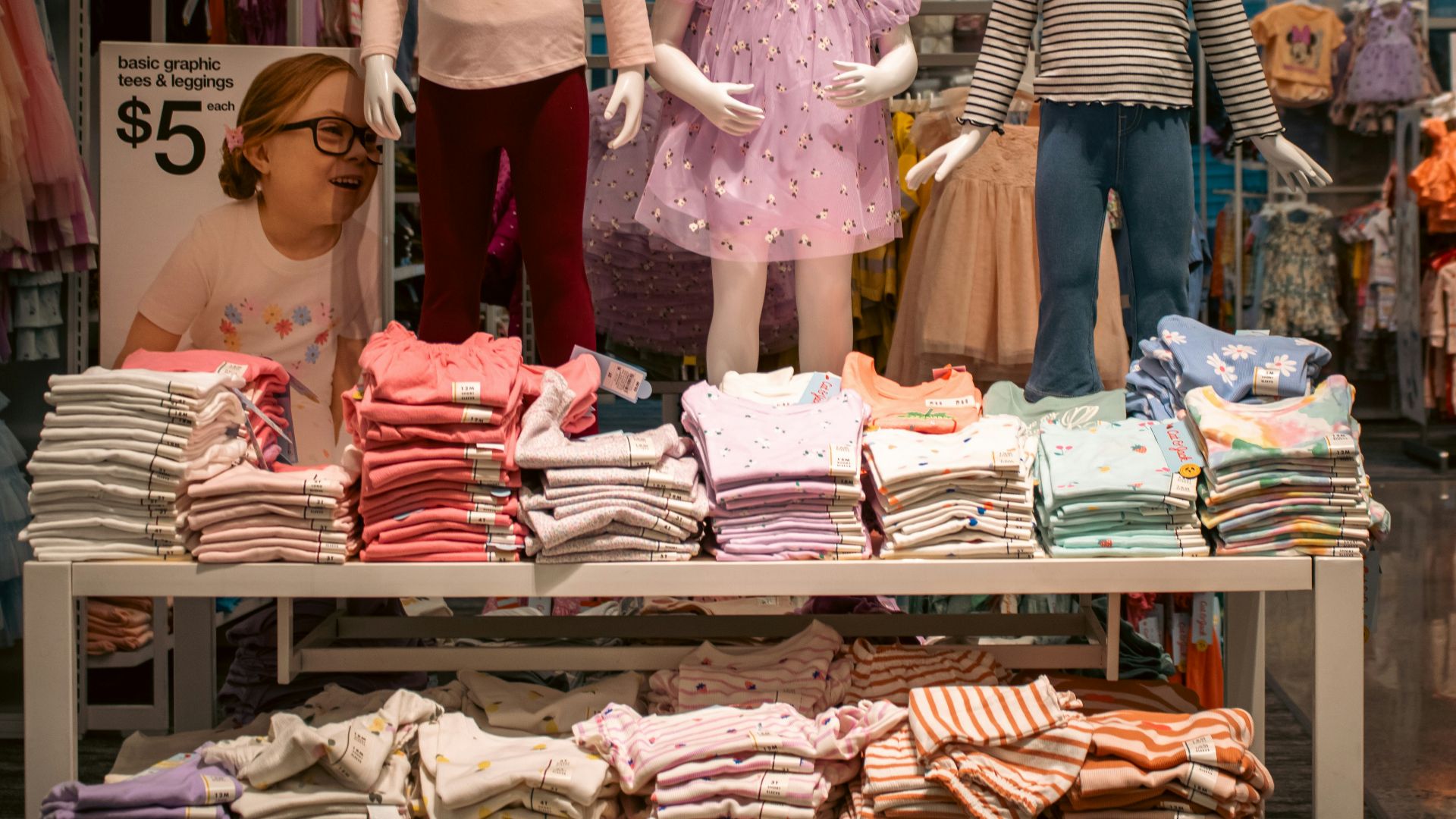 Clothing display with child mannequins at a store.