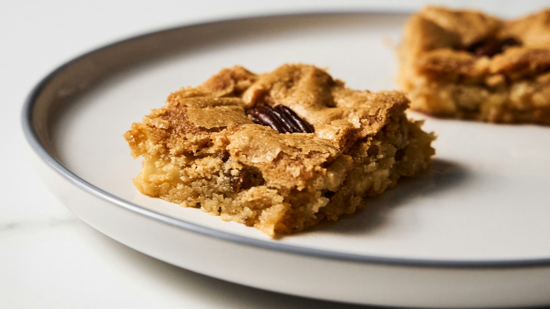 a white plate topped with two pieces of food
