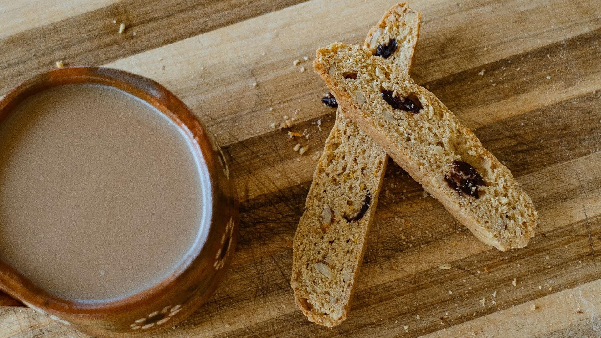 a wooden cutting board topped with a cup of coffee