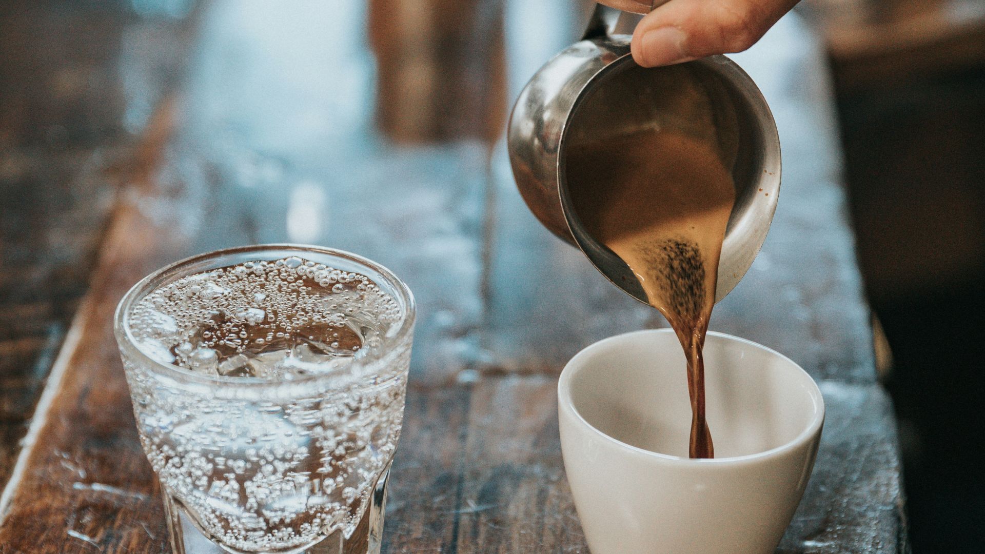 person pouring coffee in mug