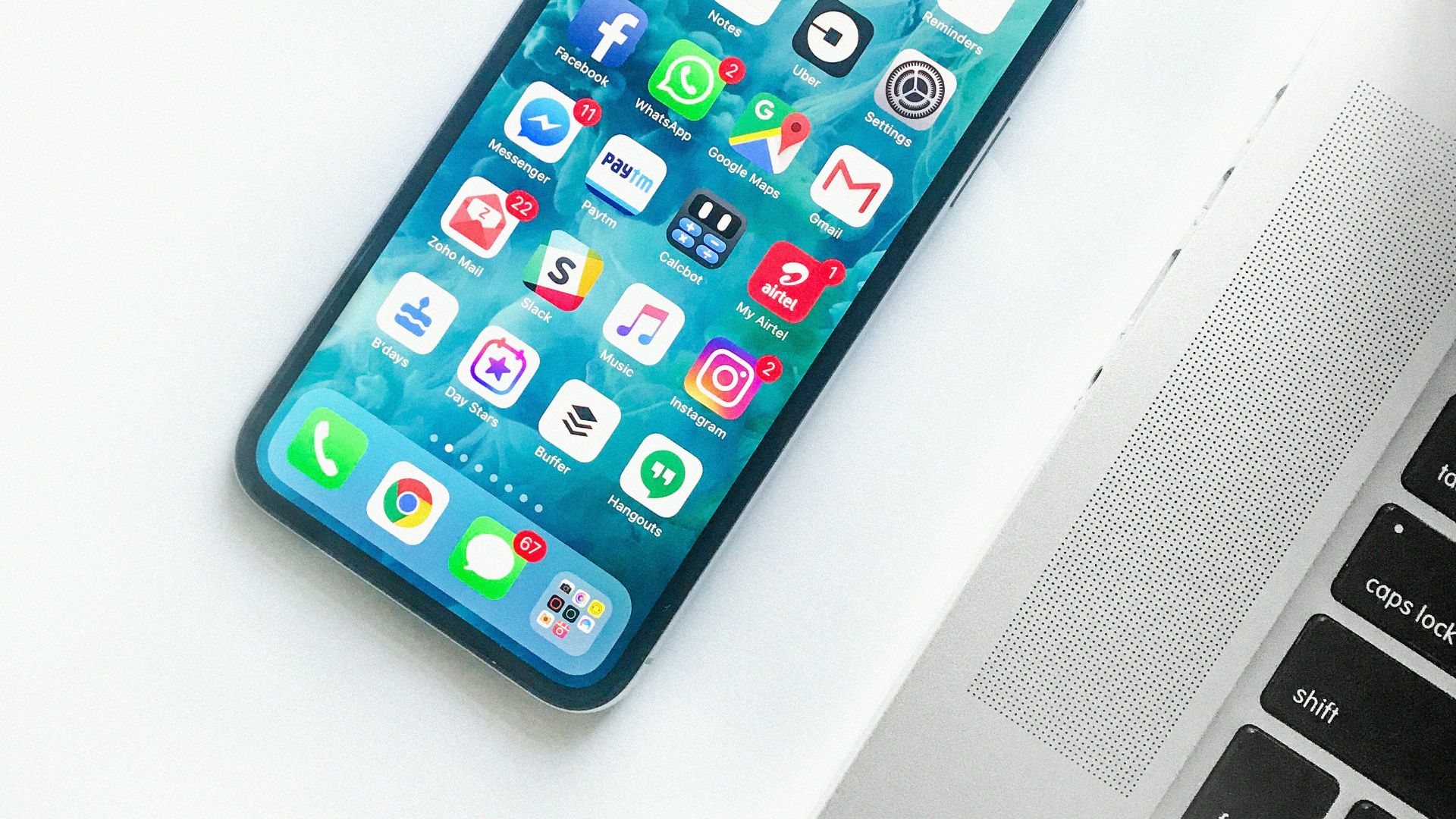 white smartphone near laptop