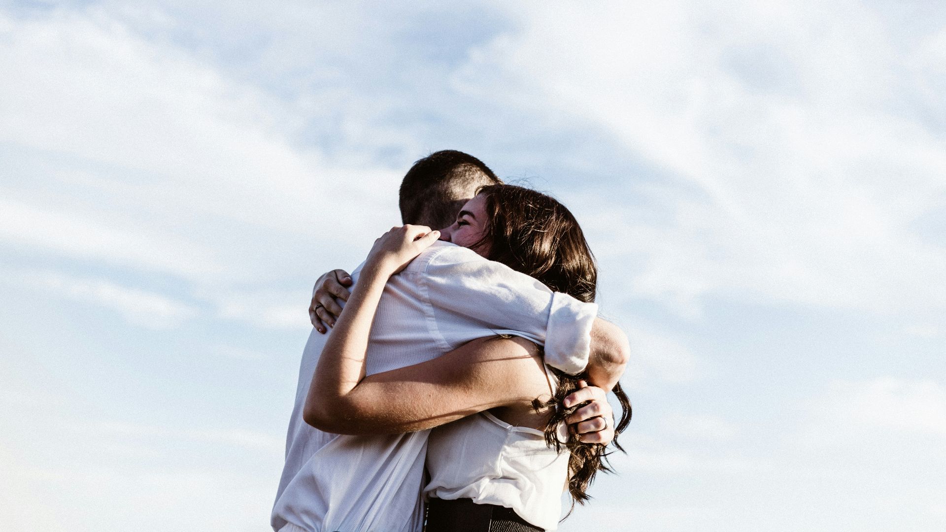 man and woman hugging each other photography