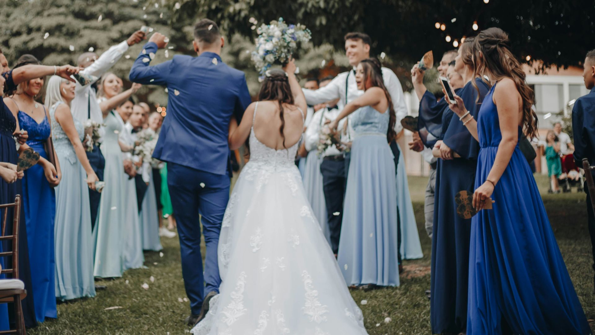 people in white dress dancing on green grass field during daytime