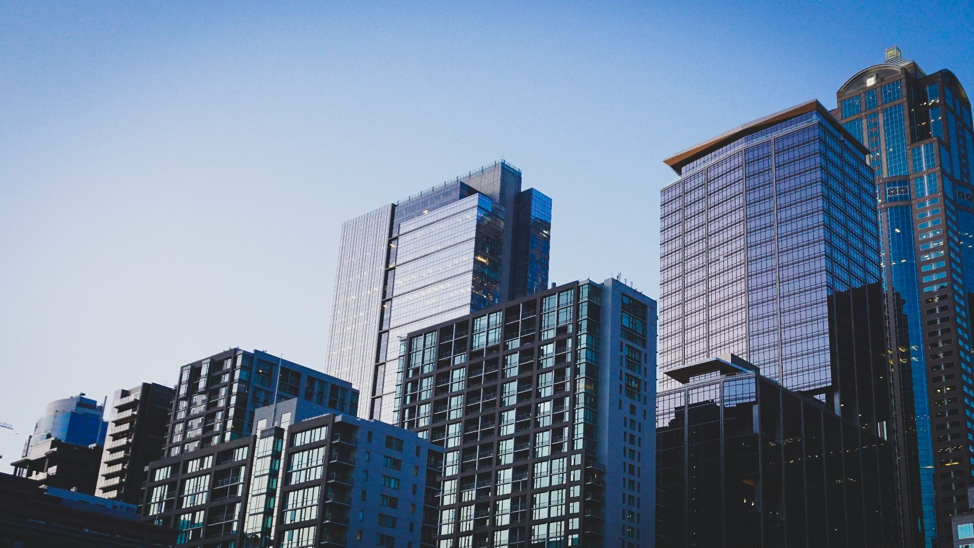 white and blue glass walled high rise building