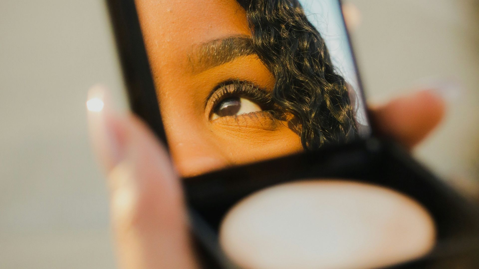 a woman holding a compact compact compact compact compact compact compact compact compact compact compact compact