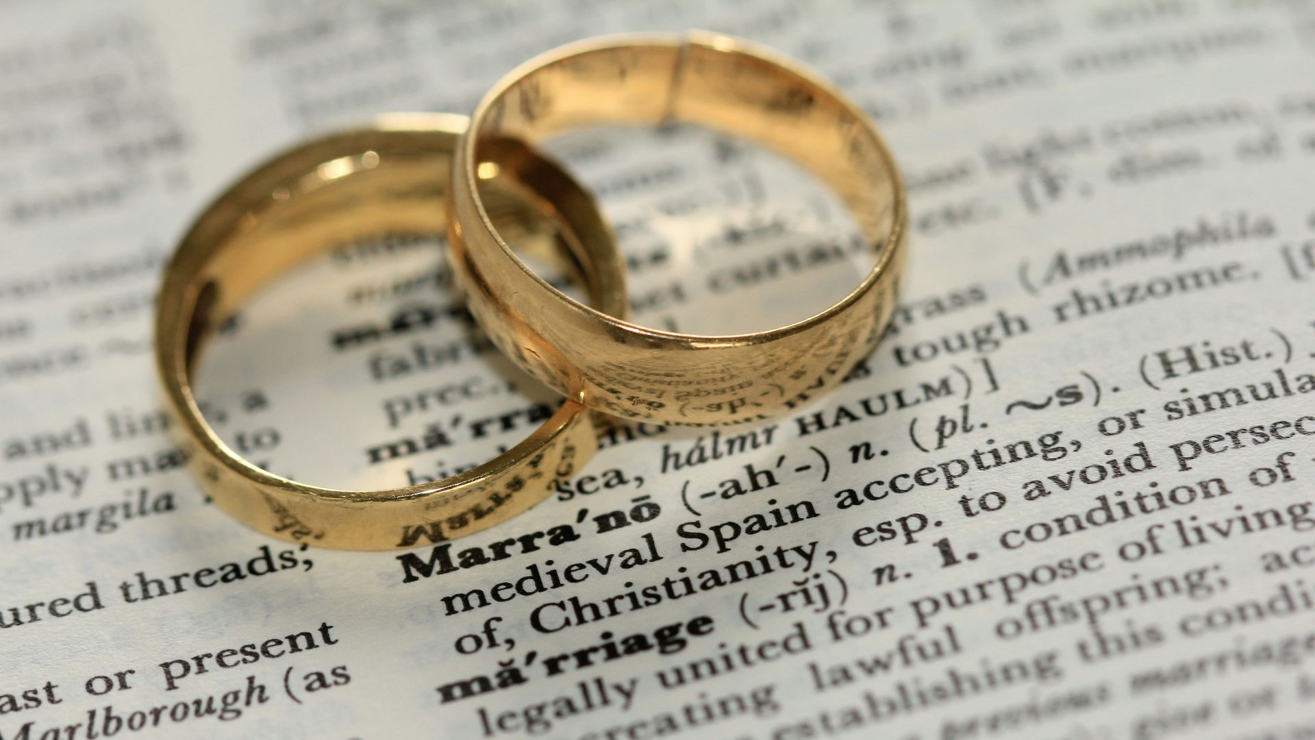 two gold-colored rings on paper