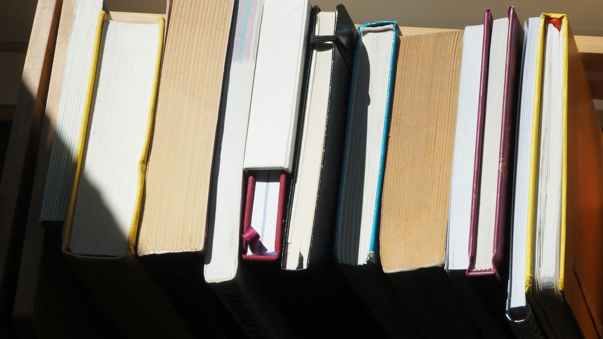 a row of books sitting on top of a shelf