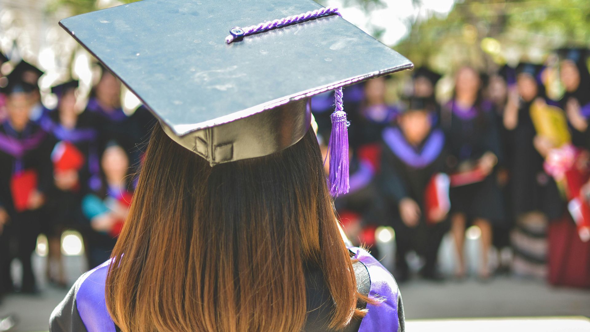woman wearing academic cap and dress selective focus photography
