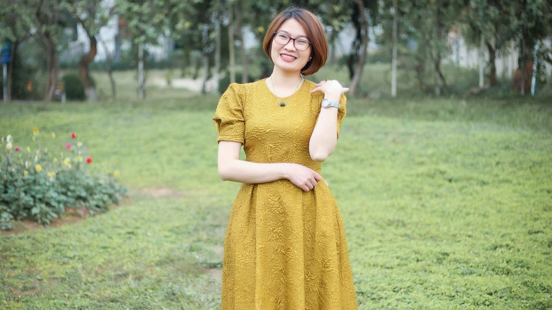 a woman in a yellow dress standing in a field