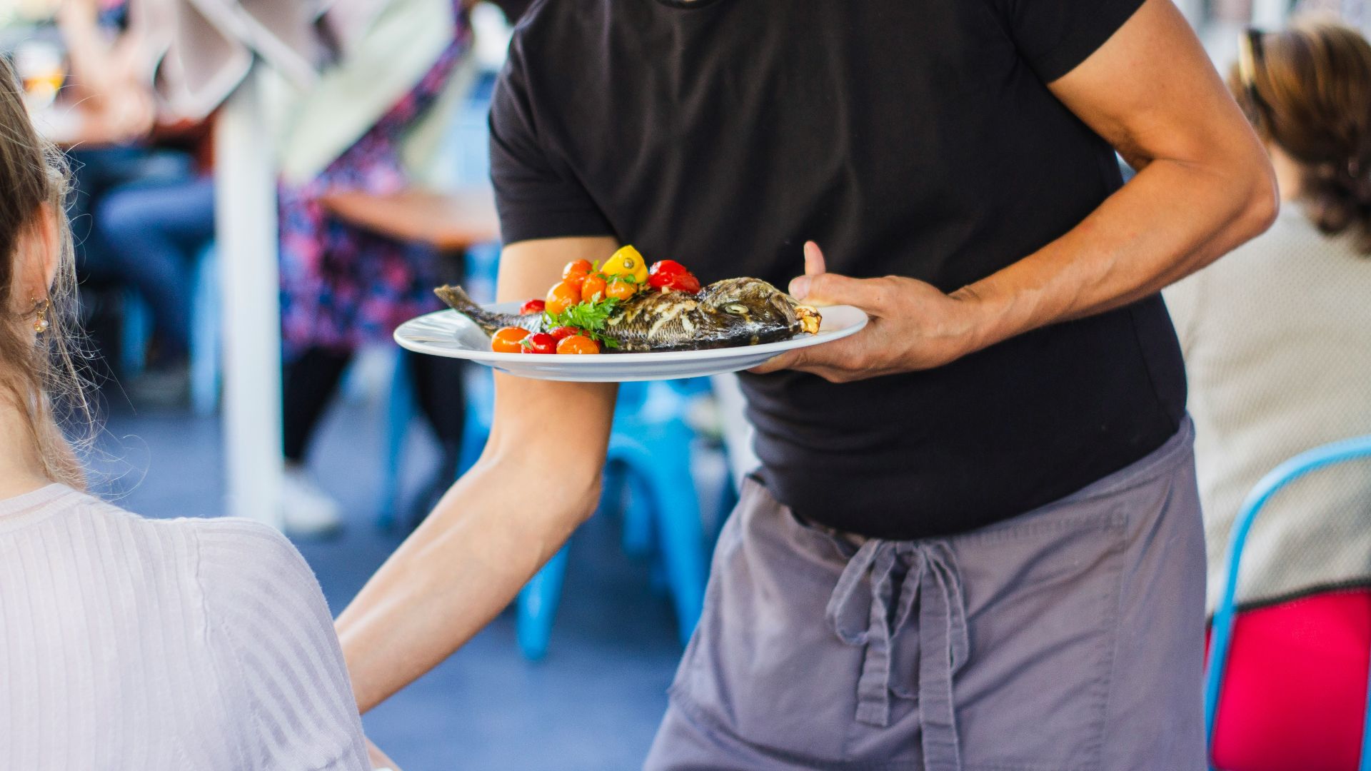 man standing and holding plate