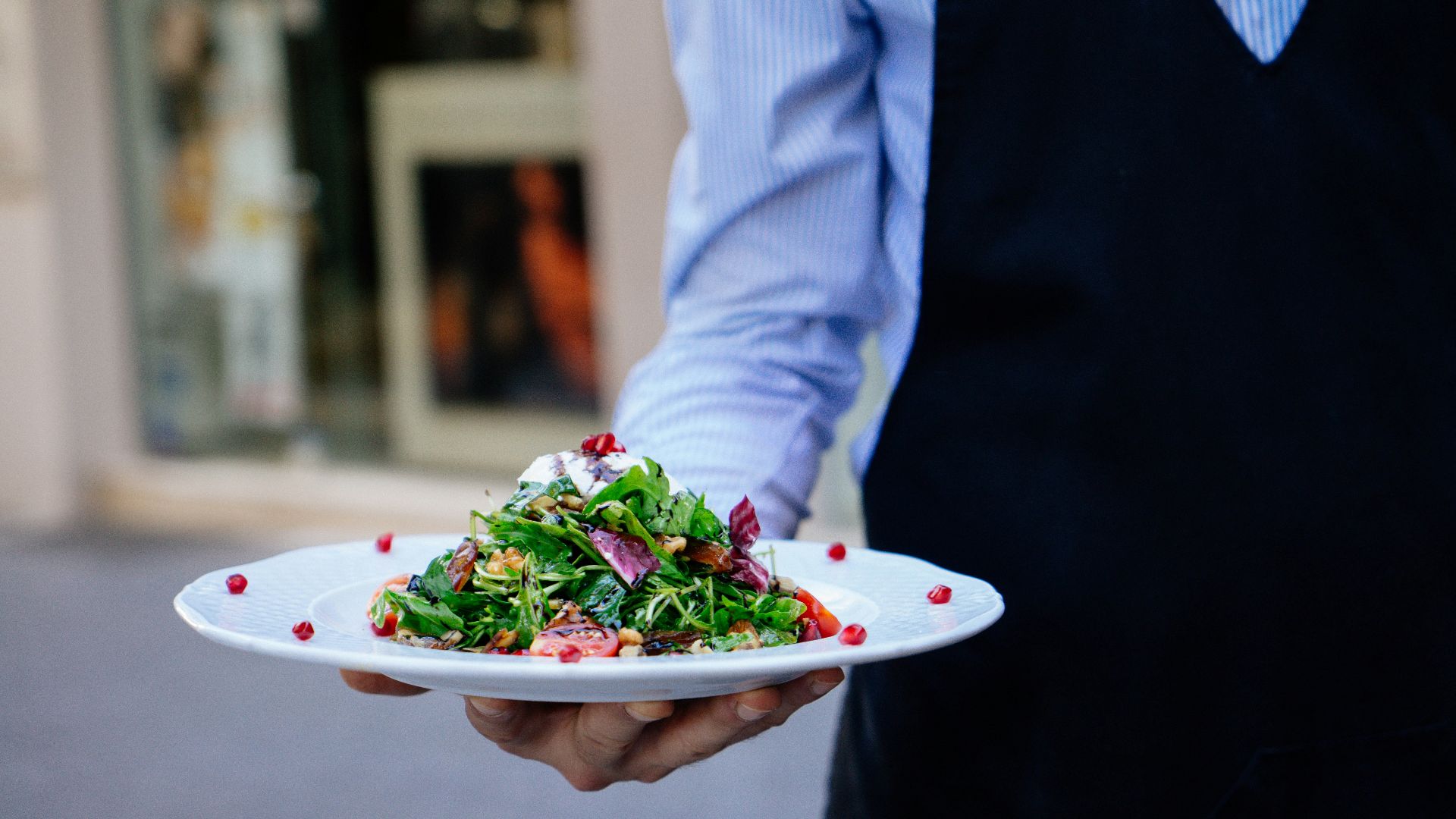 person holding a plate of salad