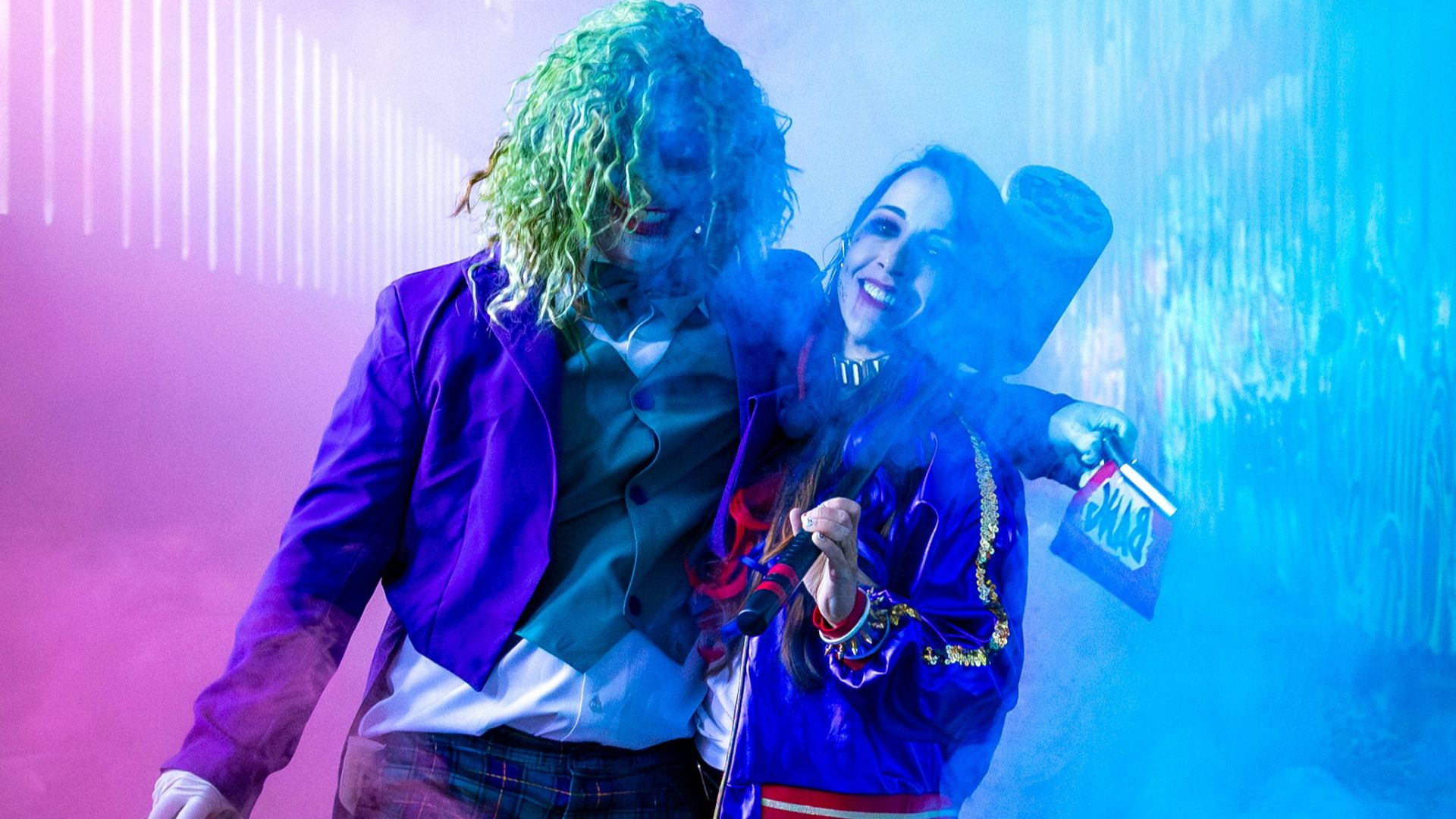 Two people in joker and harley quinn costumes