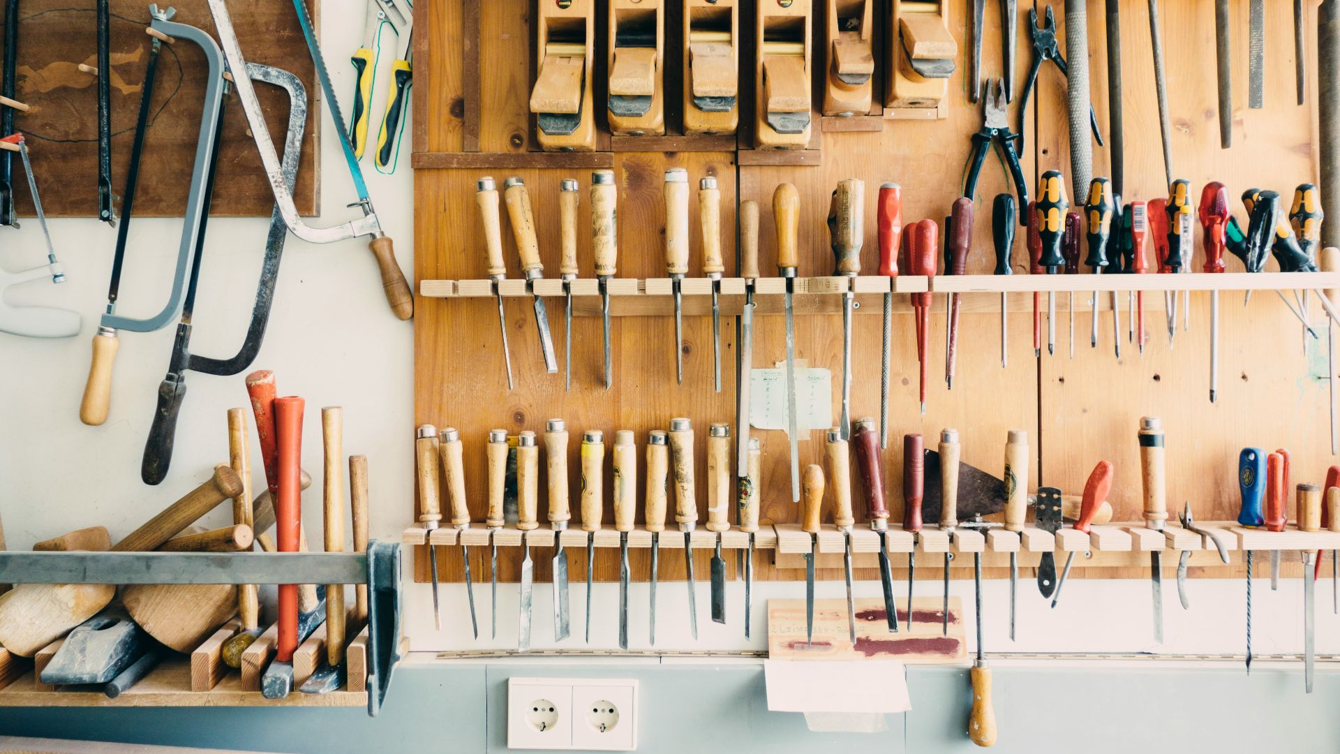 assorted handheld tools in tool rack