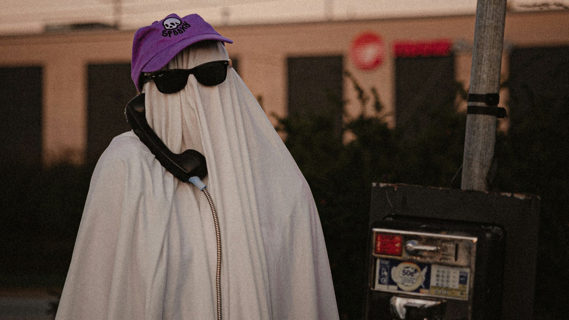 a person in a white cloak and a purple hat