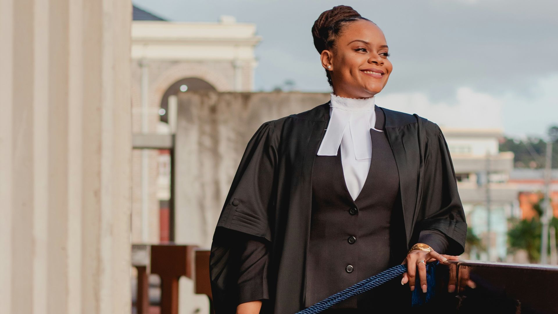 a woman in a black dress holding a blue bag