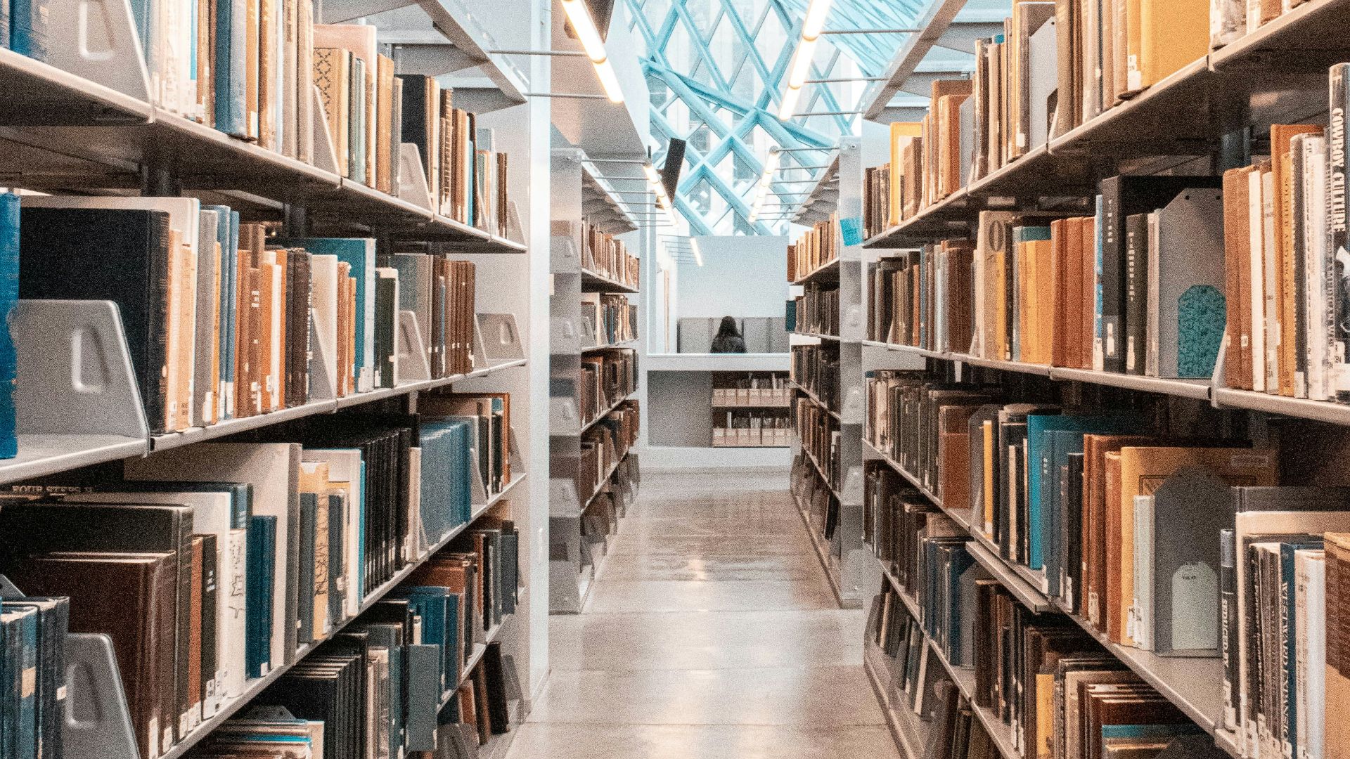 brown wooden book shelves in library