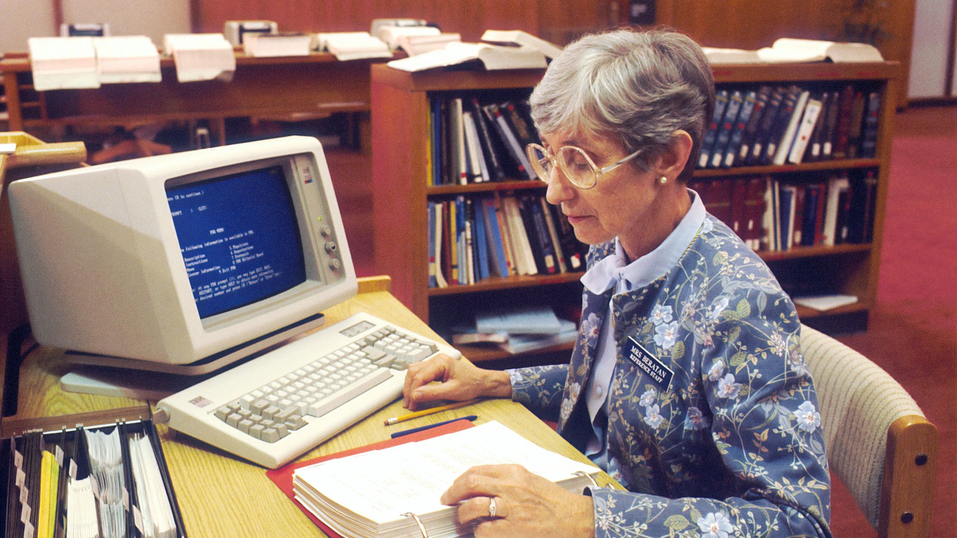 woman sitting at desk with desktop computer