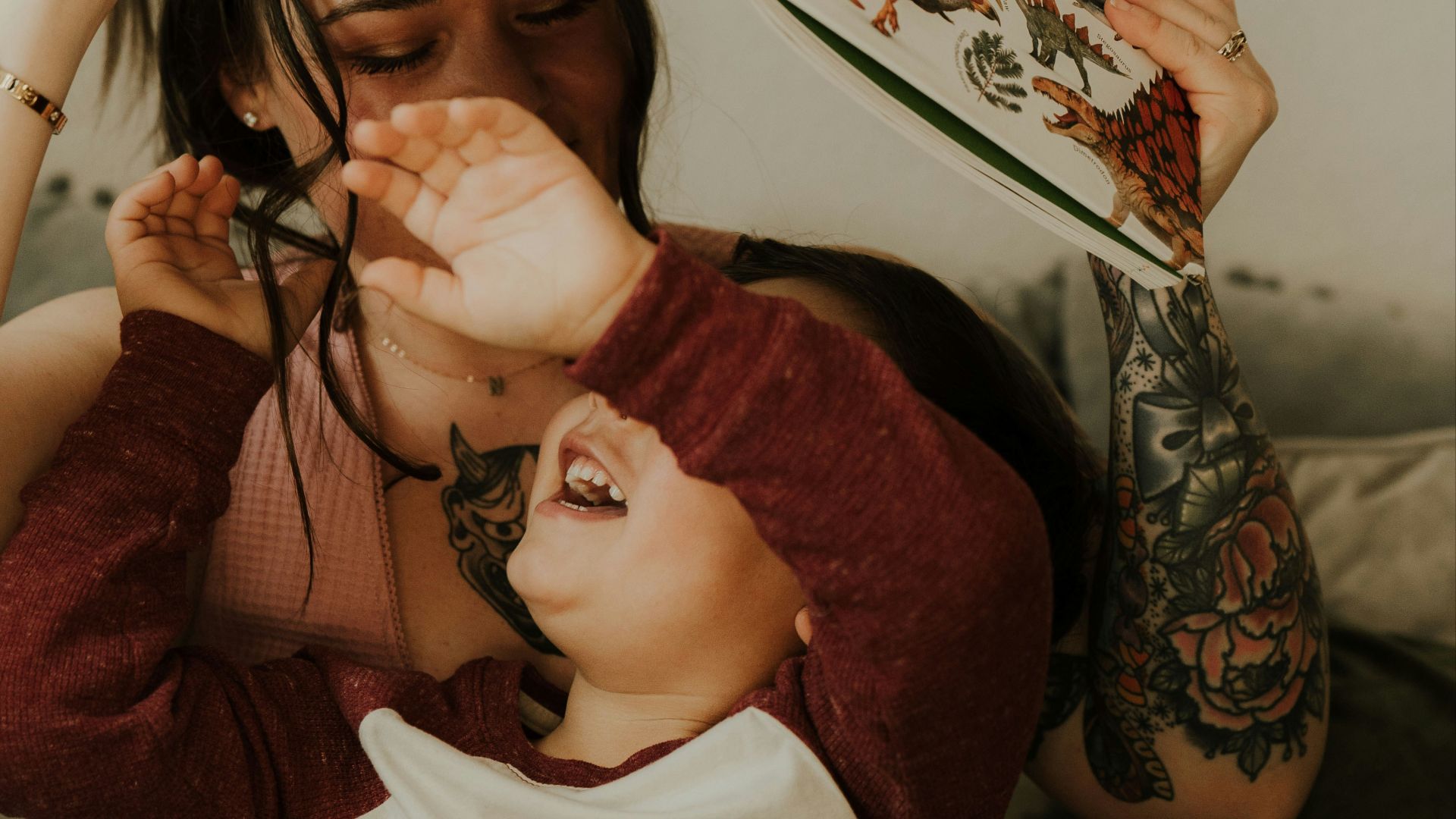 a woman is holding a book over her head