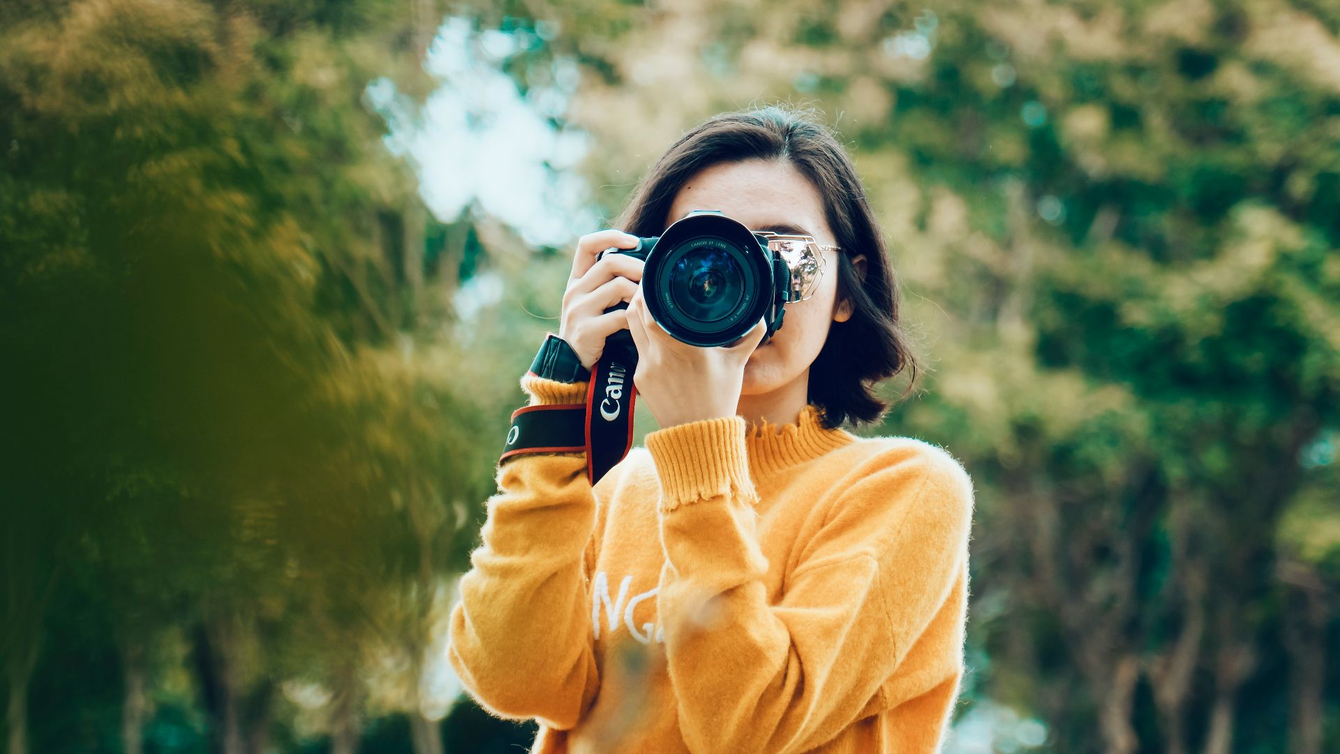 woman holding DSLR camera
