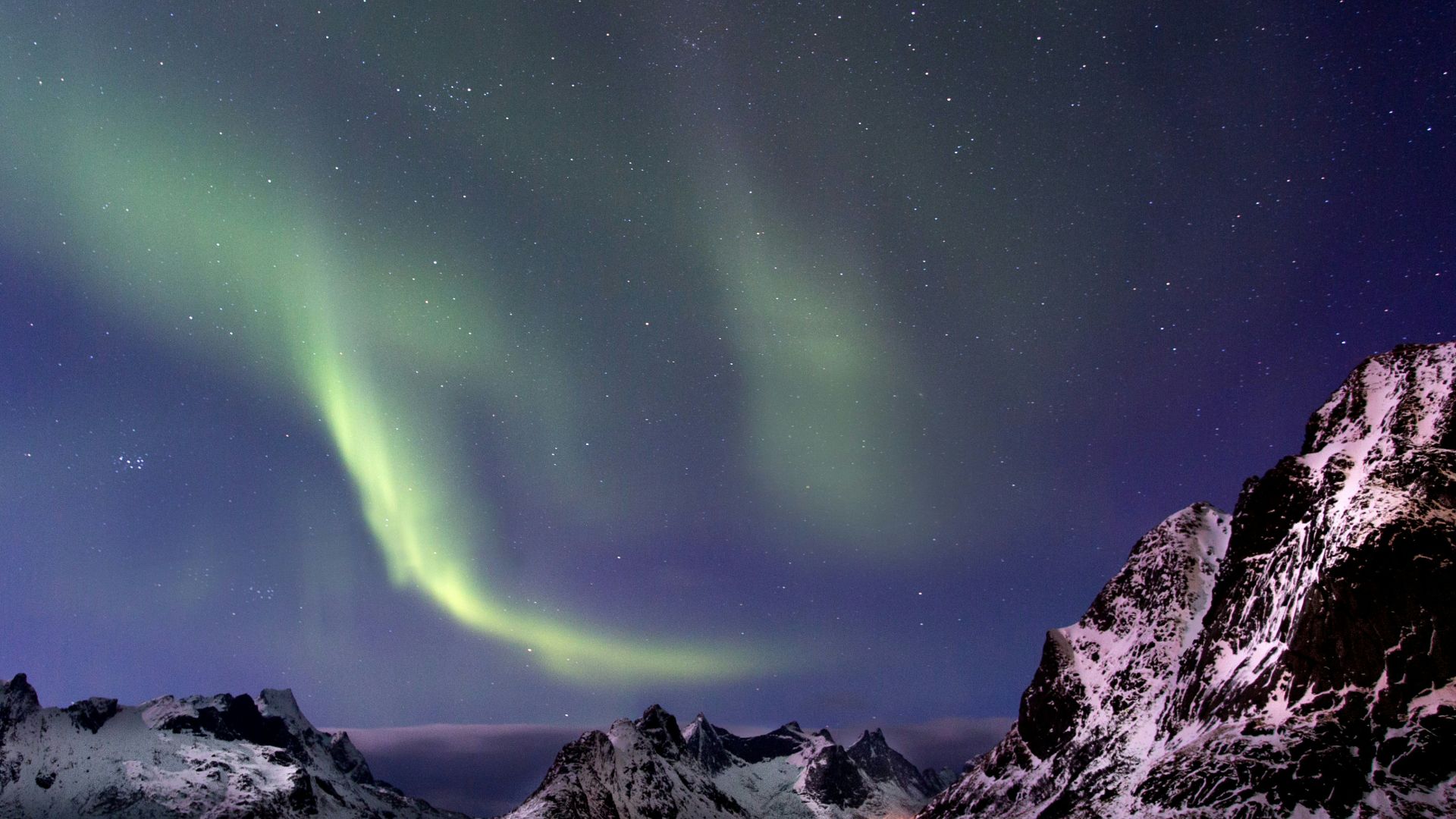 white and black mountains under green sky