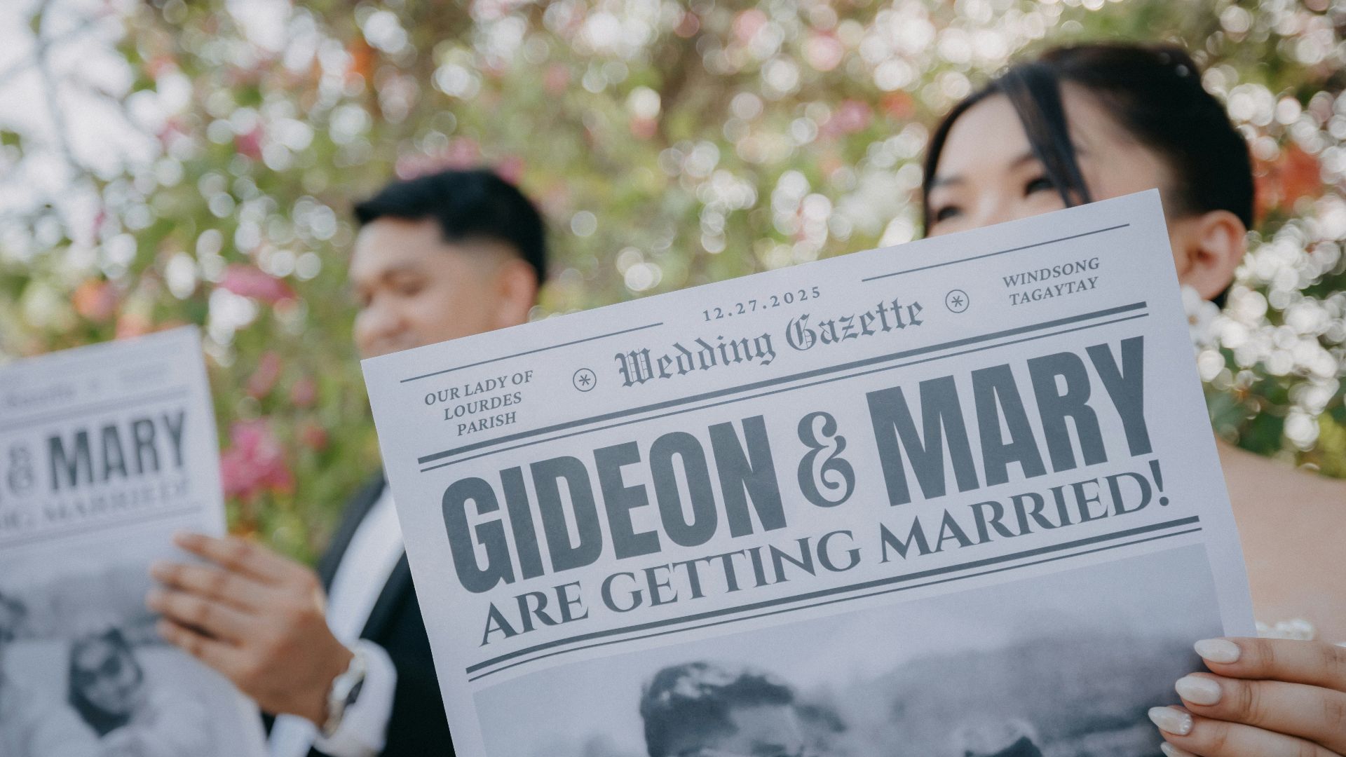 Couple holding newspaper announcing their marriage.
