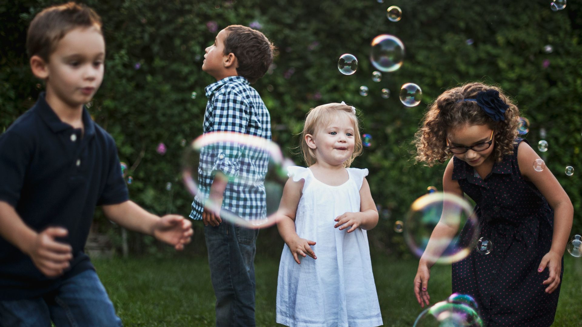 girl in white dress standing beside man in blue and white plaid dress shirt