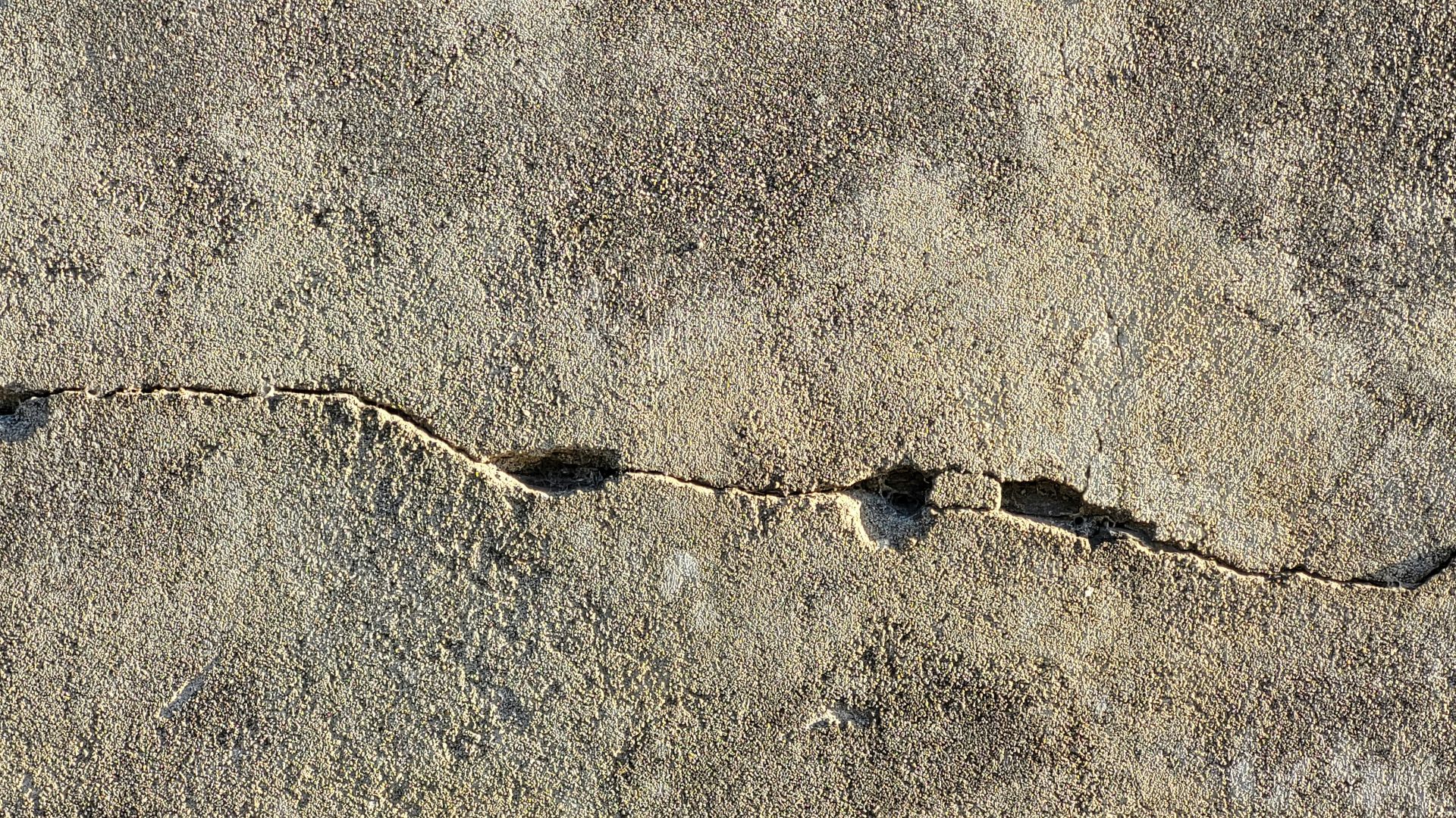 a close up of a crack in a concrete wall