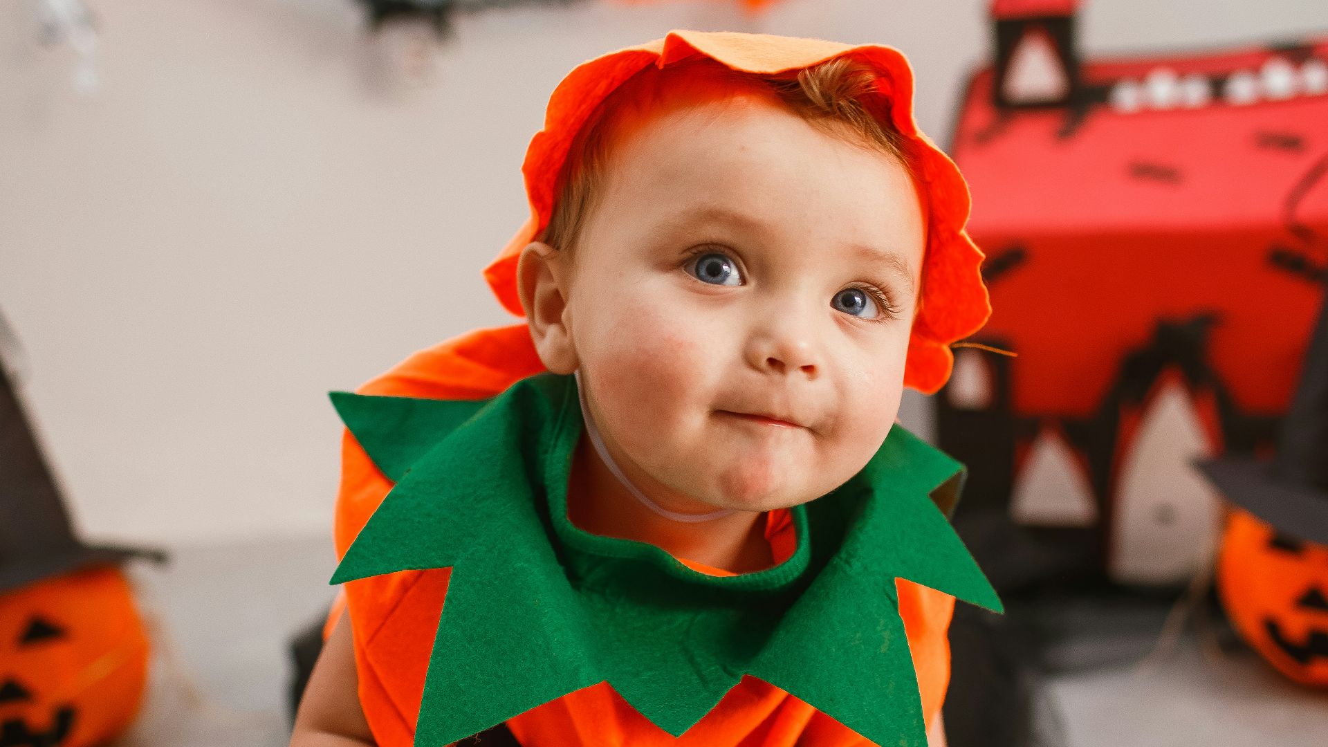 a little boy dressed up as a pumpkin