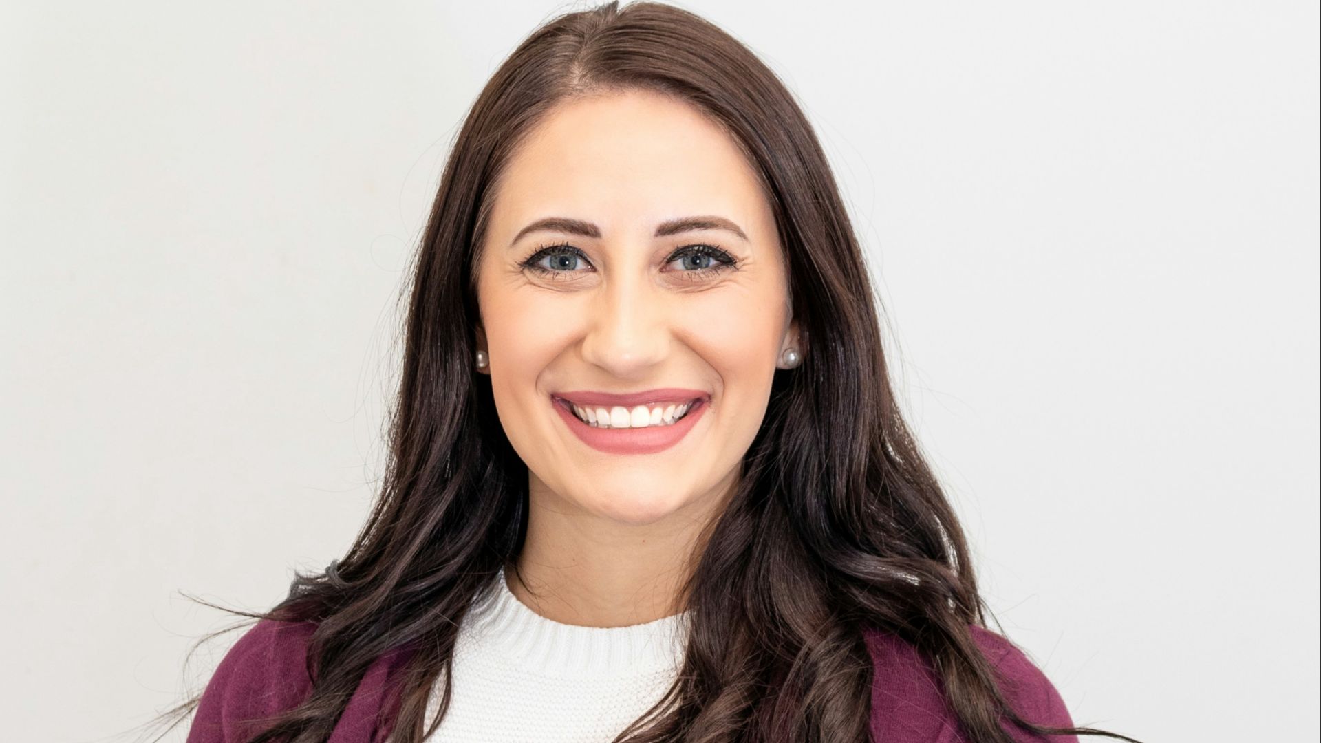 woman in red cardigan smiling